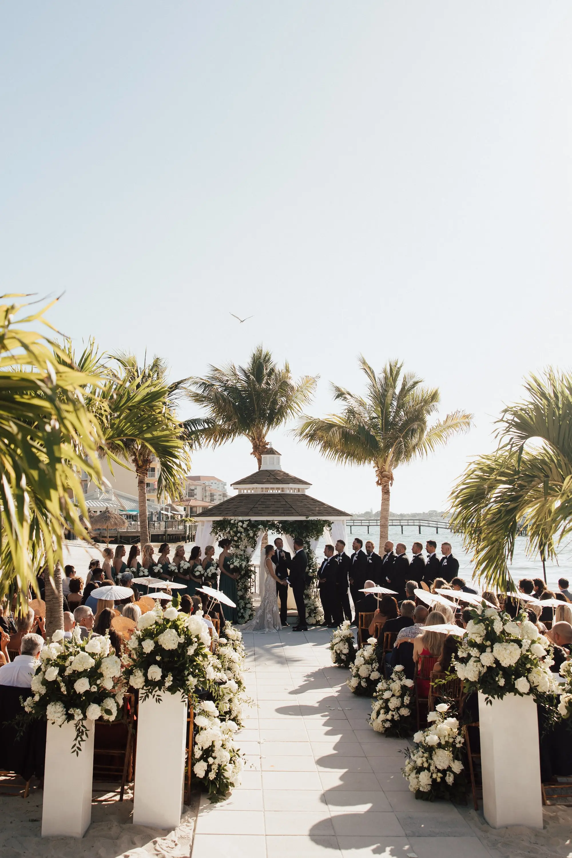 Bride and Groom Outdoor Waterfront Gazebo Wedding Ceremony Vow Exchange Wedding Portrait | Lush White Florals in Greenery Arrangement Ceremony Aisle Decor Ideas | Tampa Bay Event Venue Isla Del Sol Yacht and Country Club