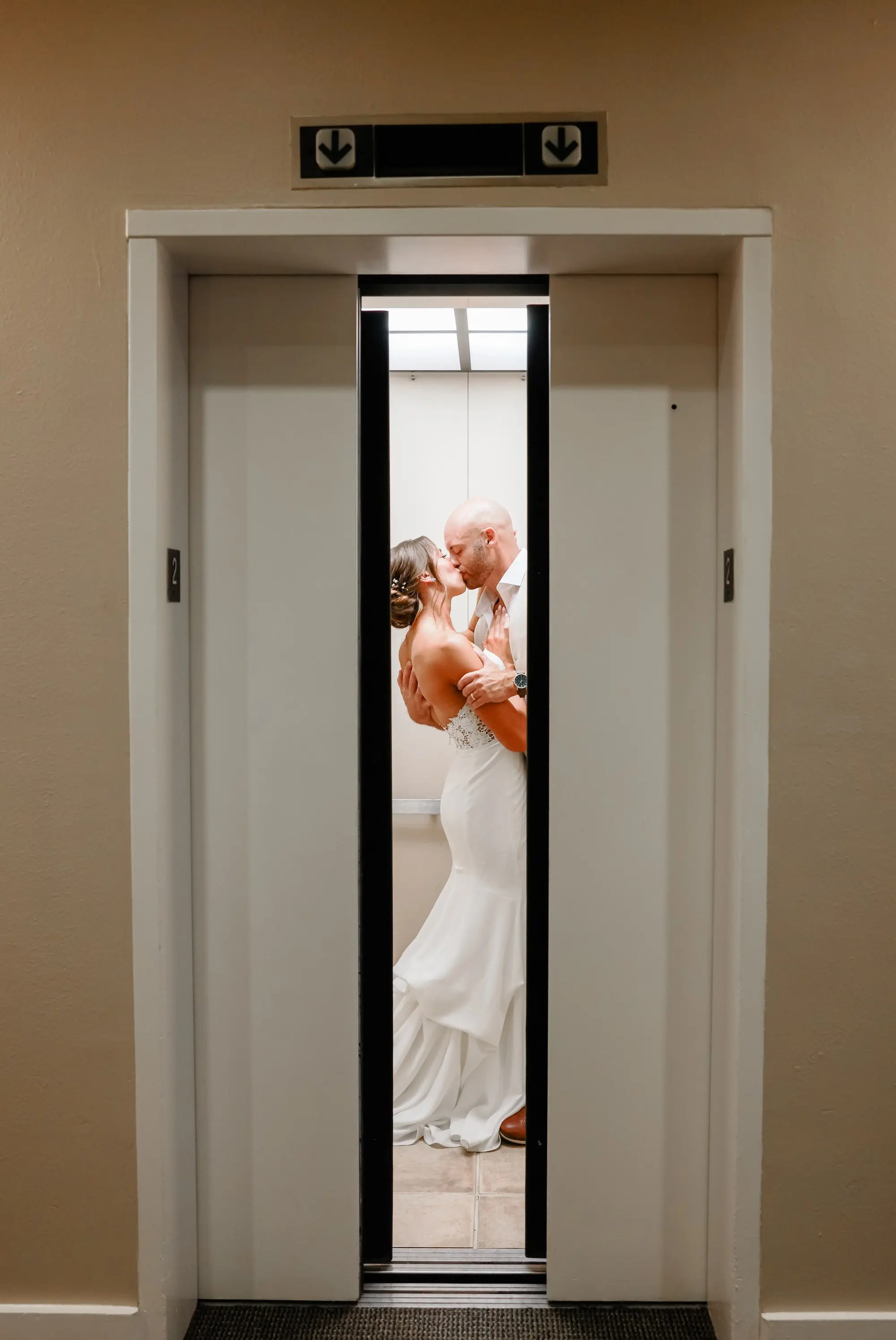 Bride and Groom Kissing in Elevator Wedding Portrait | St Pete Photographer Lifelong Photography Studio