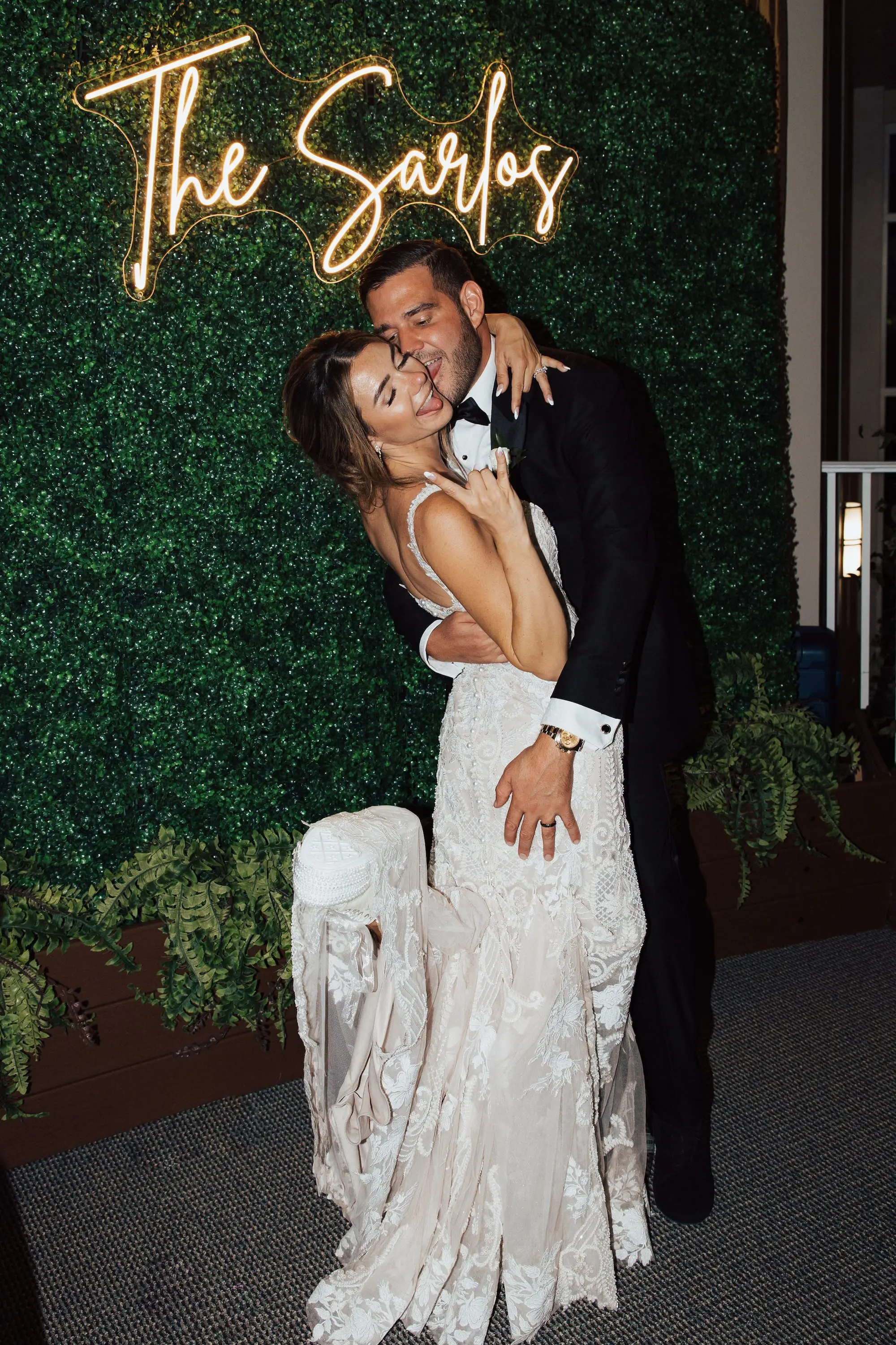 Bride and Groom Wedding Reception Portrait | Lush Green Ivy Decor Wall with Neon Last Name Sign Ideas