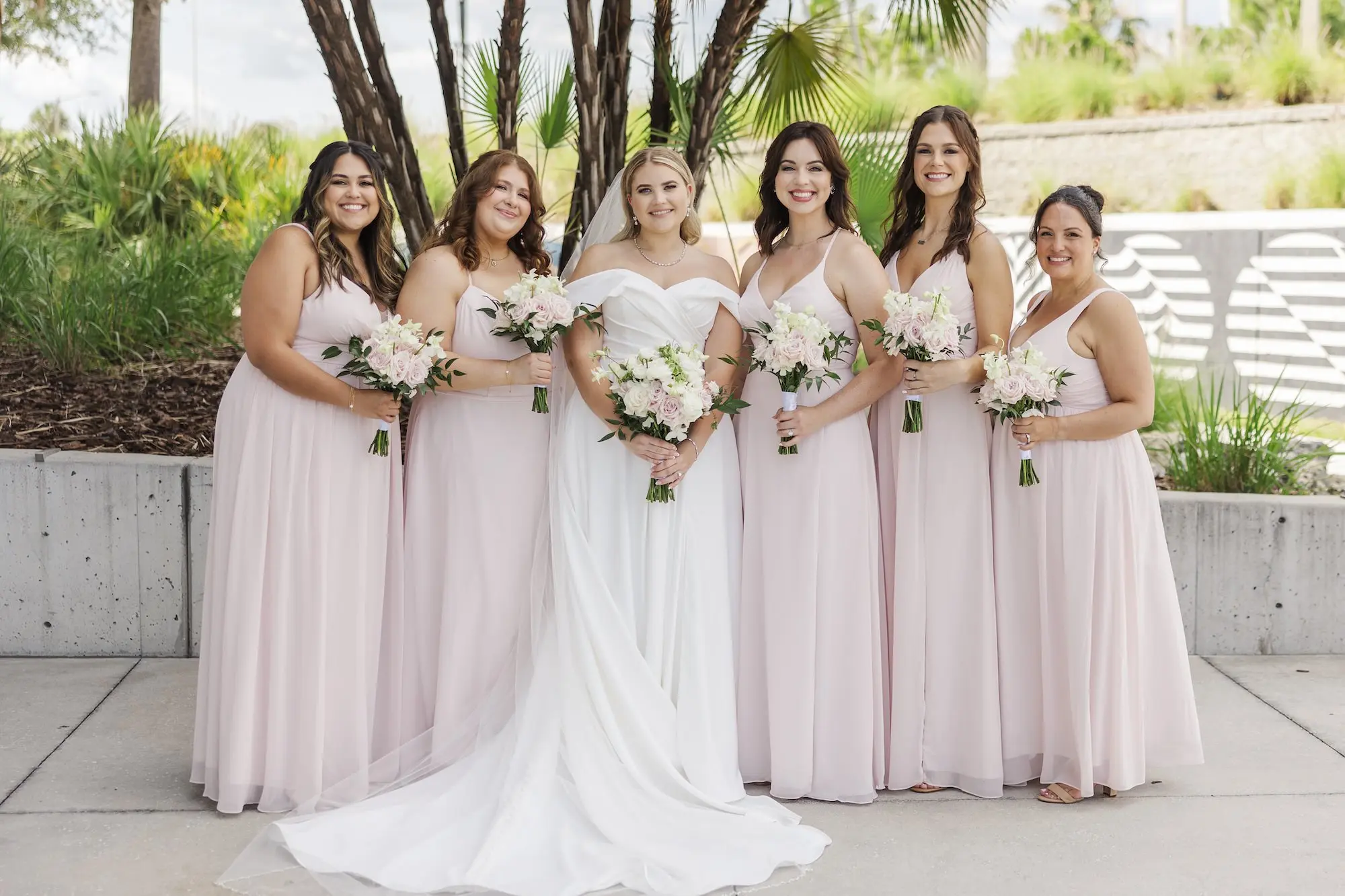 Bride with Bridesmaids Wedding Portrait | Timeless Stella York A-Line Wedding Gown with Off-the-Shoulder Neckline Inspiration | Effortless Soft Wave Curls Wedding Bridal Hair Ideas | Light Pink Dusty Pink Spaghetti Strap Chiffon Bridesmaid Dresses Inspiration | Light Pink and White Bridal Bouquet Ideas | Tampa Bay Florist Save The Date Florida | Tampa Bay Photographer Mary Anna Photography