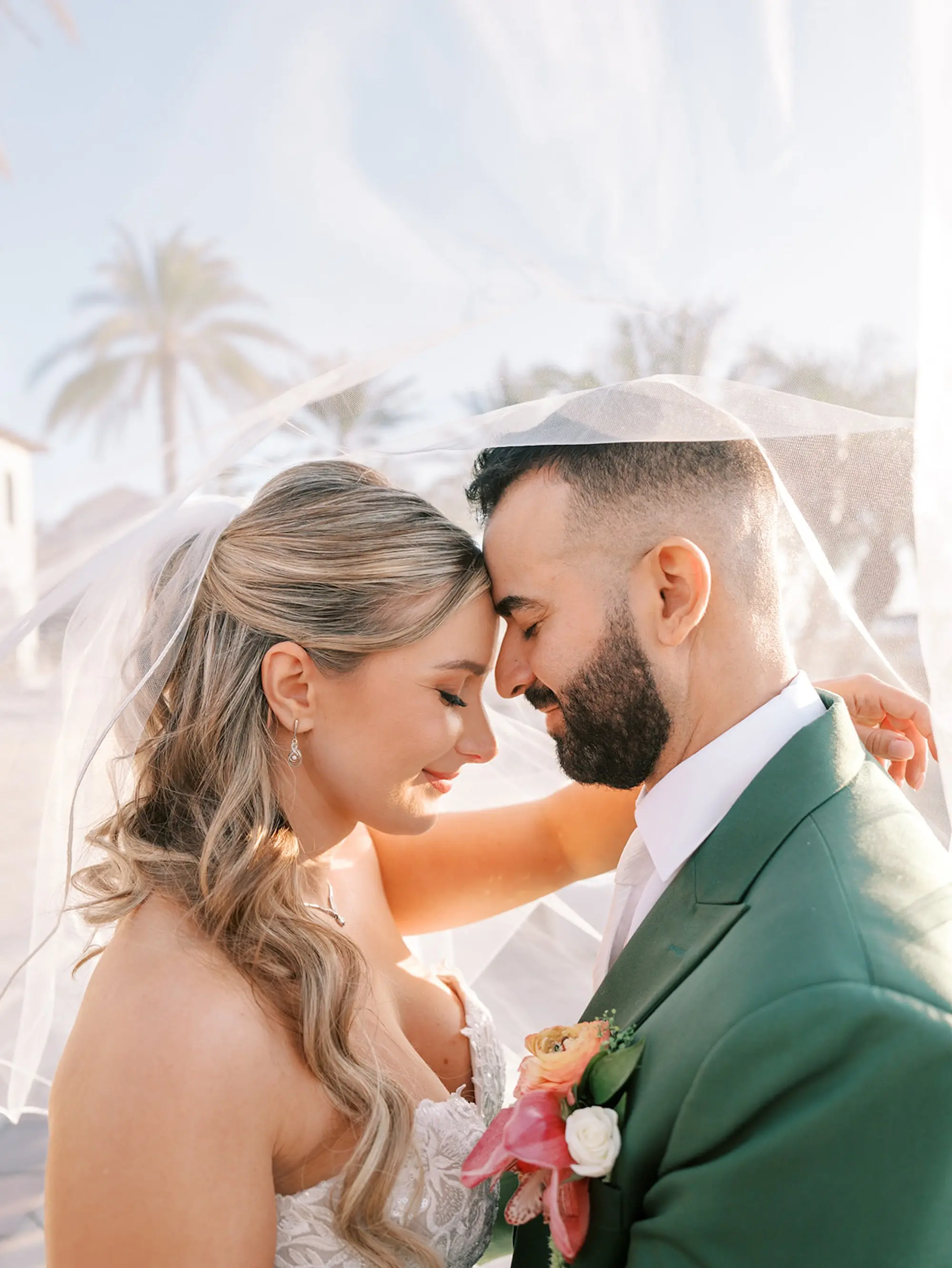 Bride and Groom Waterfront Wedding Portrait | South Tampa Outdoor Wedding Venue Westshore Yacht Club | Soft Beach Curls Half Up Half Down Wedding Hair Ideas | Tampa Bay Wedding Hair and Makeup Artist Adore Bridal Hair and Makeup | Groom Green Three-Piece Suit Ideas | South Tampa Photographer Eddy Almaguer Photography