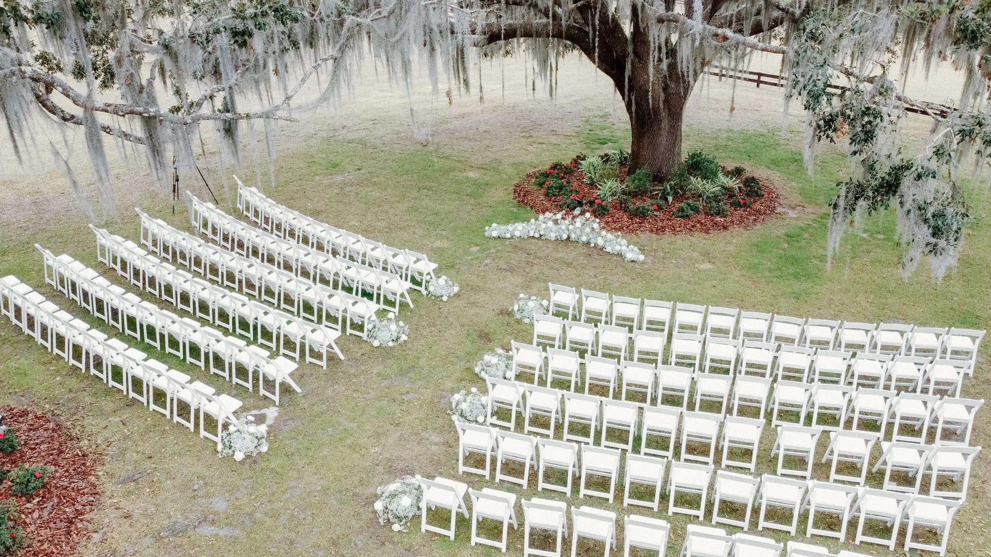 Outdoor Oak Tree Wedding Ceremony Inspiration | Baby's Breath Altar Ceremony Decor Ideas | White Ceremony Wedding Chairs Ideas | Tampa Bay Event Venue La Hacienda at Snow Hill