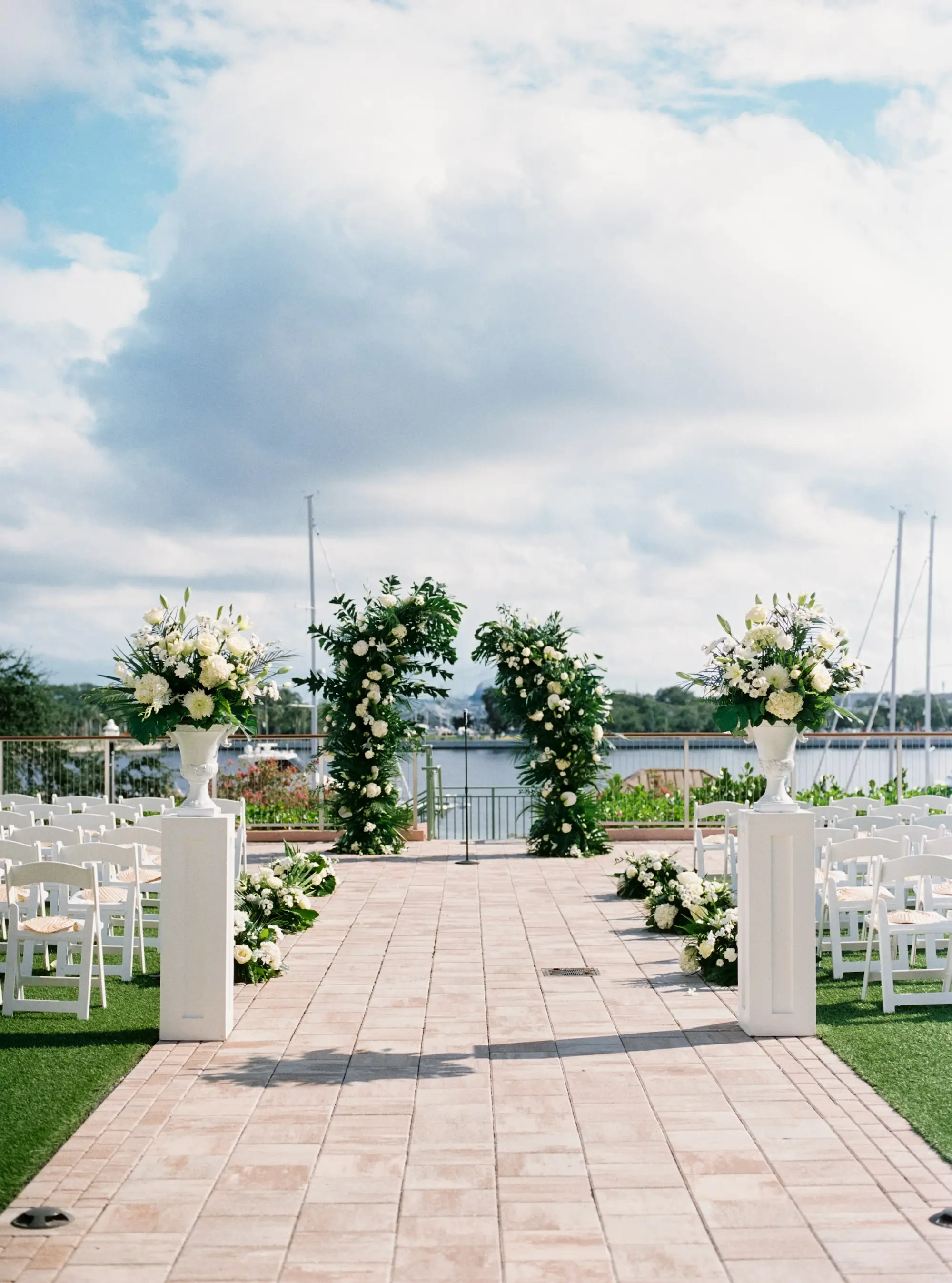 White and Green Elegant Tropical Wedding Ceremony Arch Decor Ideas | White Flowers and Greenery Altar Arrangement | Tampa Bay Florist Lemon Drops