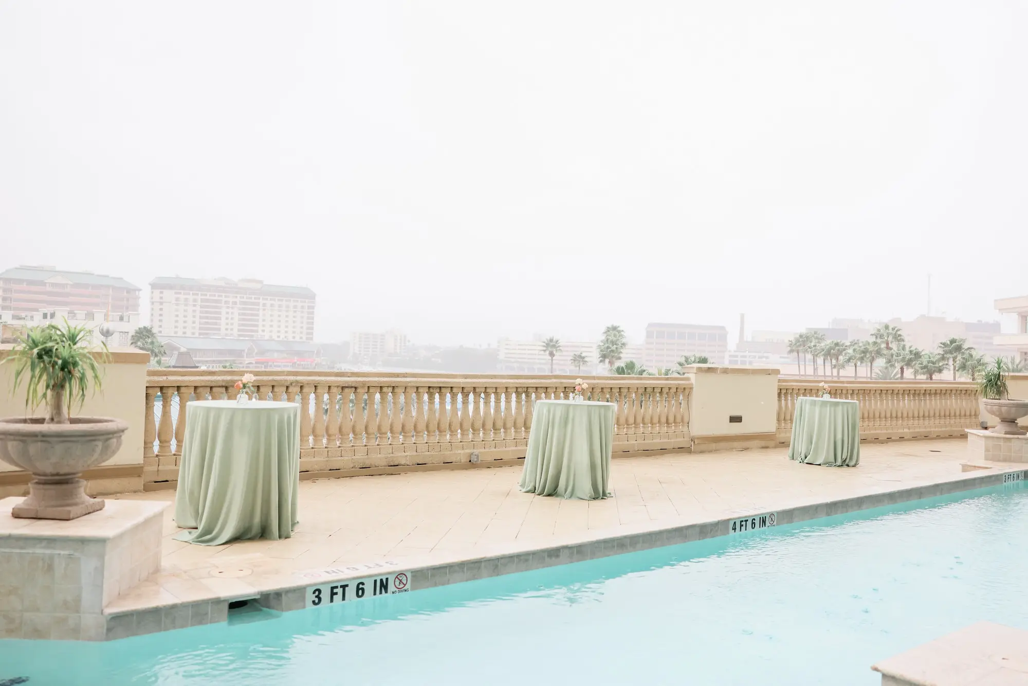 Poolside Cocktail Hour Wedding Reception Tables with Light Green Linens Decor Inspiration | Venue Embassy Suites by Hilton Tampa Downtown Convention Center | Rentals A Chair Affair