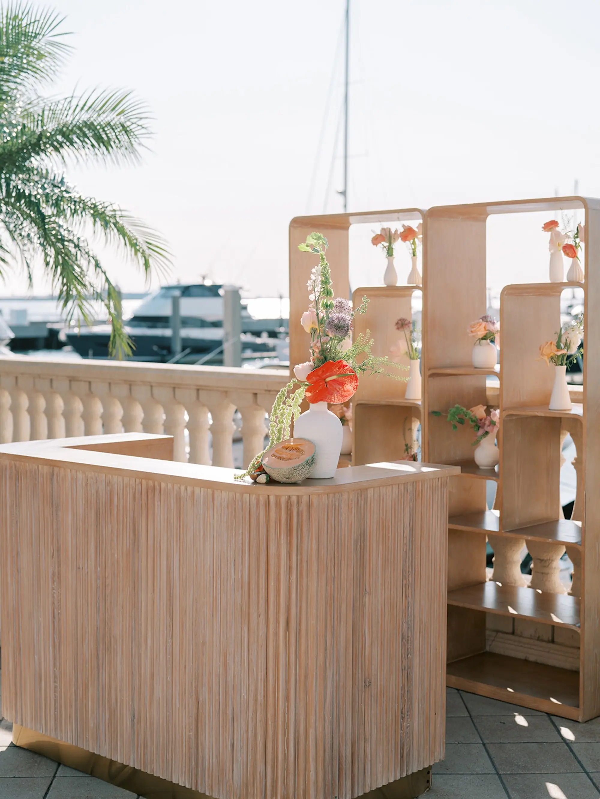 Geometric White Washed Wood Bar Wedding Reception Decor Inspiration | Tropical Coral, Pink and White Orchids, Anthium, Ranunculus Reception in Bud Vases Decor Ideas | Vibrant Fruit Dragon Fruit, Kiwi, Melon Decor Inspiration | Tampa Bay Florist Save The Date Florida | Central Florida Event Planner MDP Events | Waterfront Wedding Venue Westshore Yacht Club