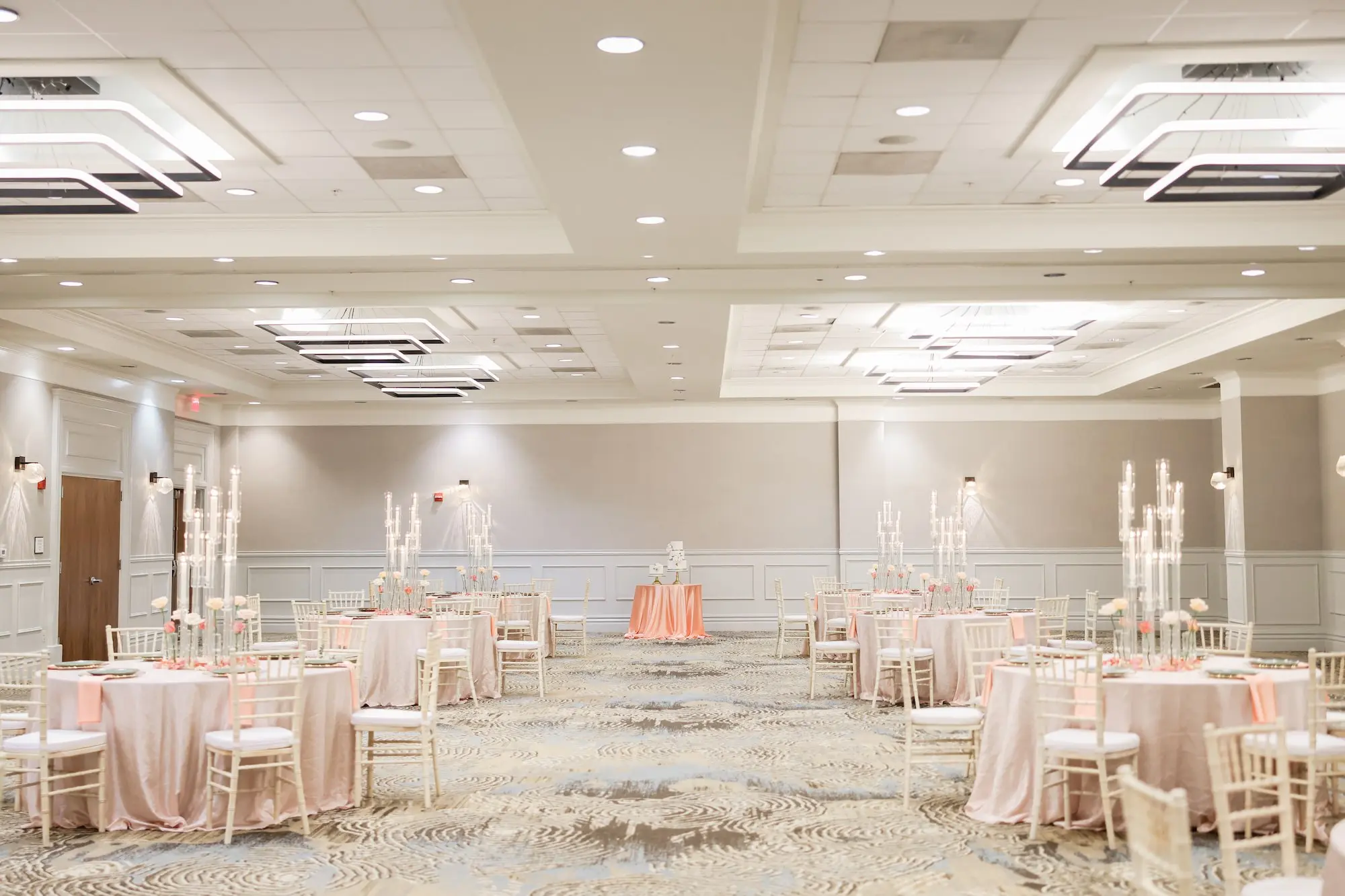 Glamorous Ballroom Wedding Reception Inspiration | Downtown Tampa Wedding Venue Ideas | Blush Linens on Round Table with White Modern Bamboo White Chairs Decor Inspiration | Tall Taper Candle Centerpieces with Single Rose Stems in Bud Vases Ideas | Venue Embassy Suites by Hilton Tampa Downtown Convention Center | Rentals A Chair Affair