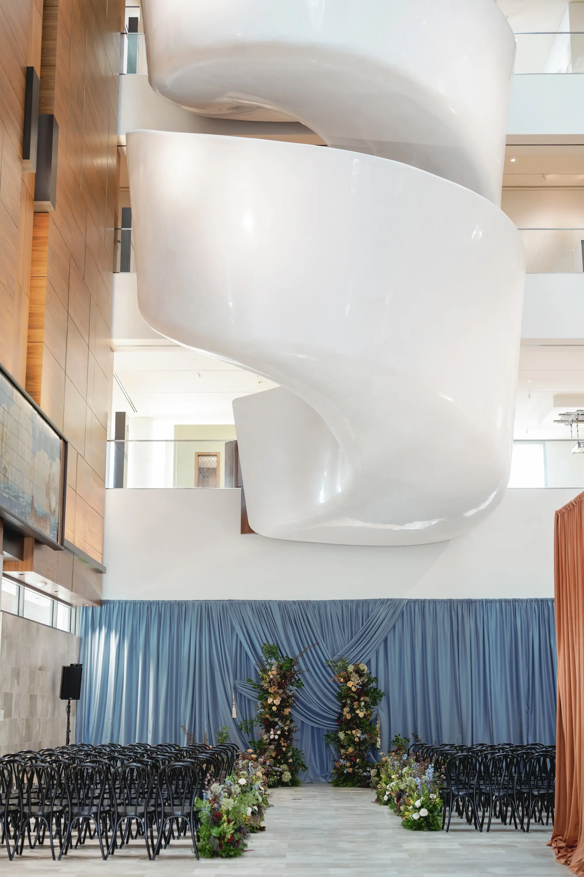 Museum of the American Arts & Crafts Movement St Pete Wedding Venue | Traditional Black Wedding Ceremony Chairs and Dusty Blue Linen Wall Drapings Ideas | Floral Columns Ceremony Altar Decor Inspiration | Floral Arrangement Aisle Decor Ideas | St Pete Florist Bruce Wayne Florals | Florida Luxury Planner Parties A'La Carte