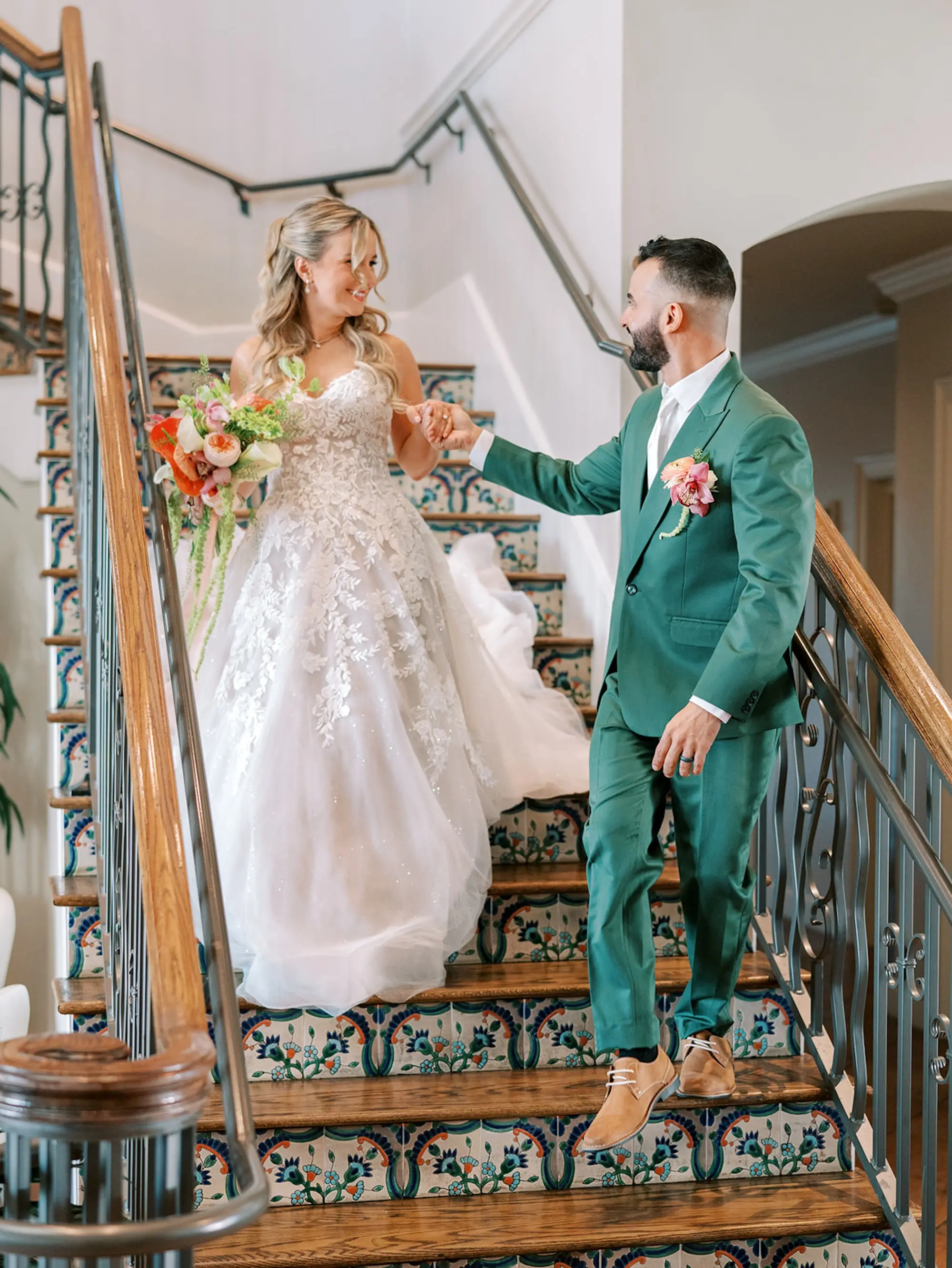 Bride and Groom Staircase Wedding Portrait | South Tampa Wedding Venue Westshore Yacht Club | ropical Coral, Pink and White Orchids, Anthium, Ranunculus Bridal Bouquet Inspiration | Tampa Bay Florist Save The Date Florida | Soft Beach Curls Half Up Half Down Wedding Hair Ideas | Tampa Bay Wedding Hair and Makeup Artist Adore Bridal Hair and Makeup | South Tampa Photographer Eddy Almaguer Photography | Strapless A-Line Tulle Wedding Gown with Sweetheart Neckline and Floral Lace Inspiration