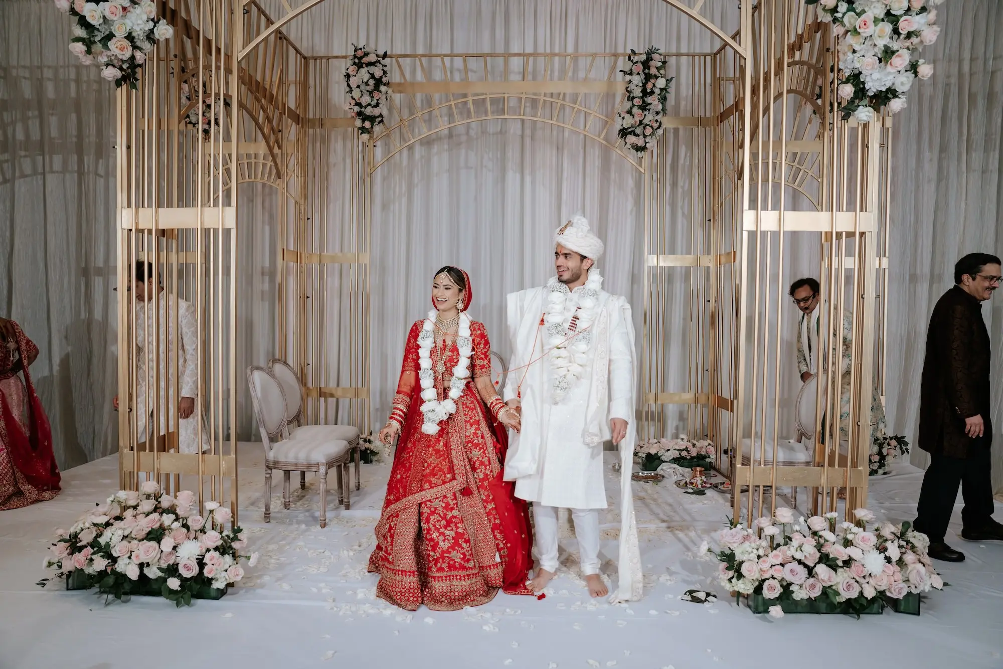 Traditional Red and Pink Indian Wedding Ceremony Decor Ideas | Gold Mandap with White and Blush Rose Flower Arrangement Inspiration | Bride Red Lehenga with Intricate Gold Embroidery Ideas | Red Matching Dupatta Ideas | Groom White Sherwani Turban and Stole Inspiration | Event Venue Grand Hyatt Tampa Bay