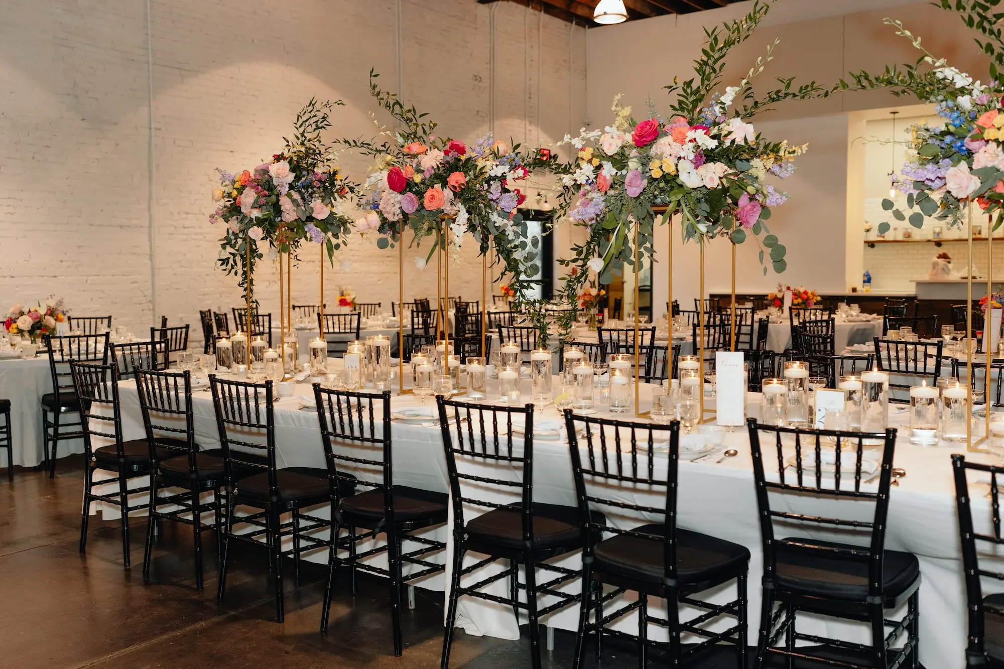 Romantic Colorful Blue Wedding Reception Centerpiece Decor Inspiration | Pink, Yellow, and Blue Flowers with Greenery | Black Chiavari Chairs | Tampa Bay Event Venue Haus 820