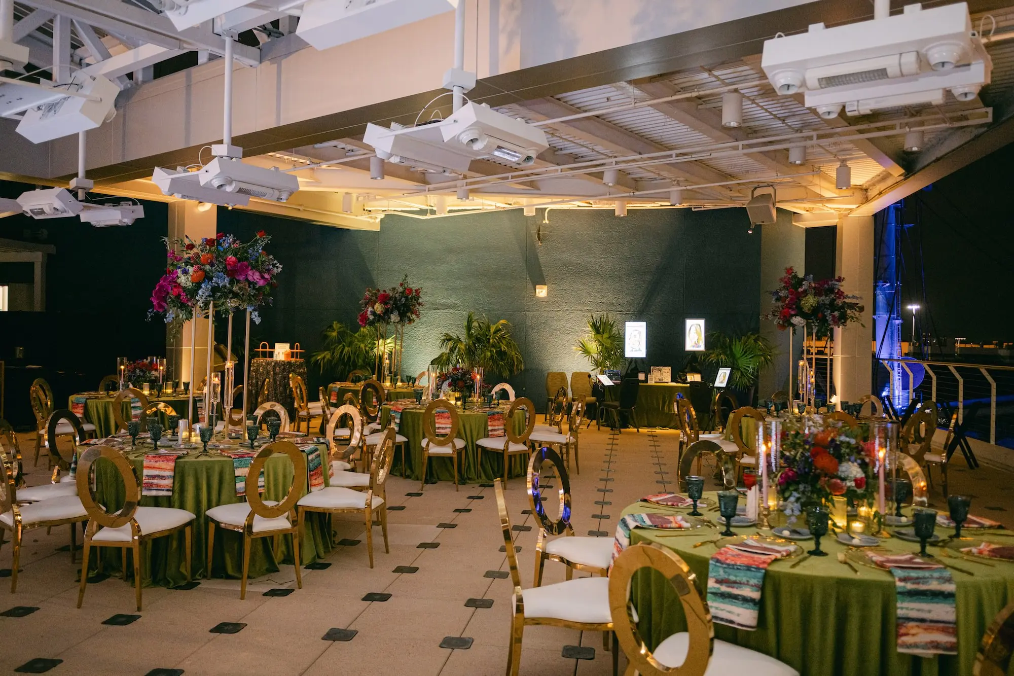 Luxurious Ballroom Wedding Reception | Modern Gold-Framed with White Seats and Back | Tall Gold Centerpieces with Vibrant Jewel-Toned Florals Wedding Reception Decor Ideas | Tampa Bay Event Venue Florida Aquarium | Planner Blue Skies Weddings and Events | Green Linens with Colorful Patterned Napkins Wedding Reception Decor Inspiration