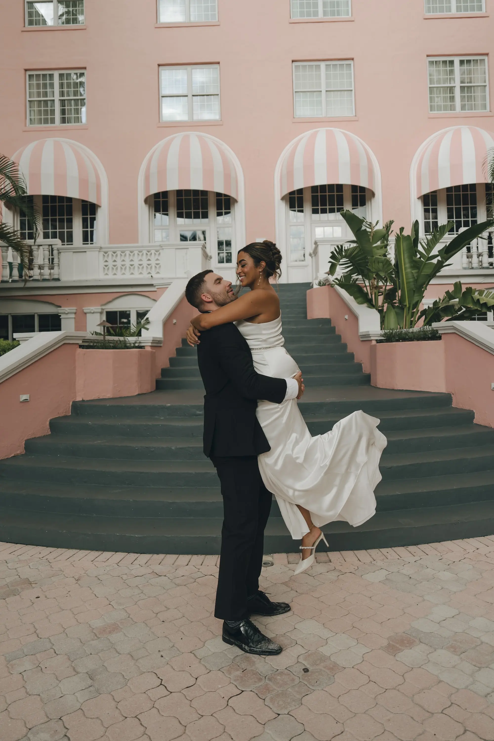 Bride and Groom Staircase Wedding Portrait | Historic Pink Palace St Pete Beach Wedding Venue Don CeSar | Beachfront Wedding Venue Inspiration | Destination Beach Hotel Ideas | Photographer Amber Yonker Photography