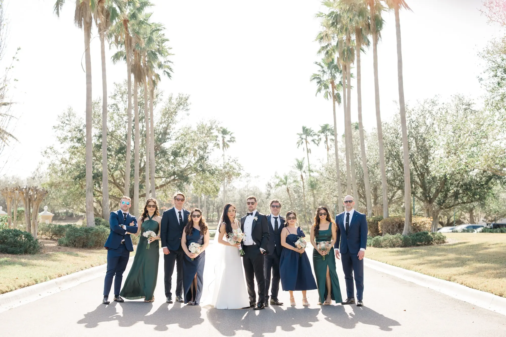 33Romantic Pastel and Navy Sarasota Wedding Inspiration jpg - Timeless Gold and Green Sarasota Wedding | Lakewood Ranch Golf & Country Club Bride and Groom in Palm Tree Lined Street with Bridal Party Wedding Portrait | Different Style Dark Green and Navy Blue Bridesmaid Dresses Ideas | Susan Elizabeth Weddings Tampa Wedding Photographer