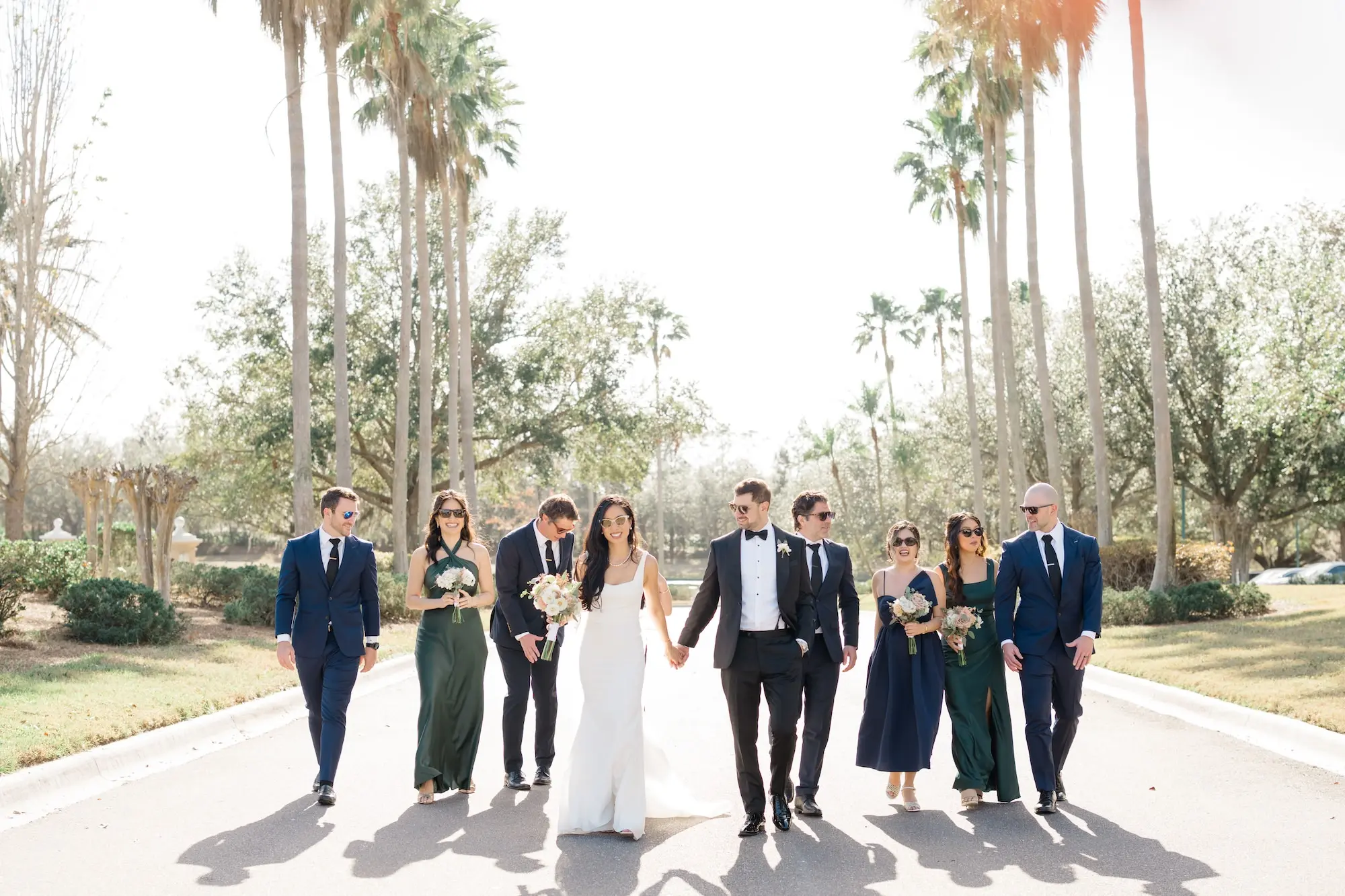 34Romantic Pastel and Navy Sarasota Wedding Inspiration jpg - Timeless Gold and Green Sarasota Wedding | Lakewood Ranch Golf & Country Club Bride and Groom in Palm Tree Lined Street with Bridal Party Wedding Portrait | Different Style Dark Green and Navy Blue Bridesmaid Dresses Ideas | Elegant A-Line Paloma Blanca Wedding Gown with Square Neckline and Traditional Chapel Length Tulle Veil Inspiration | Lush White and Blush Floral Arrangement Ideas | Susan Elizabeth Weddings Tampa Wedding Photographer
