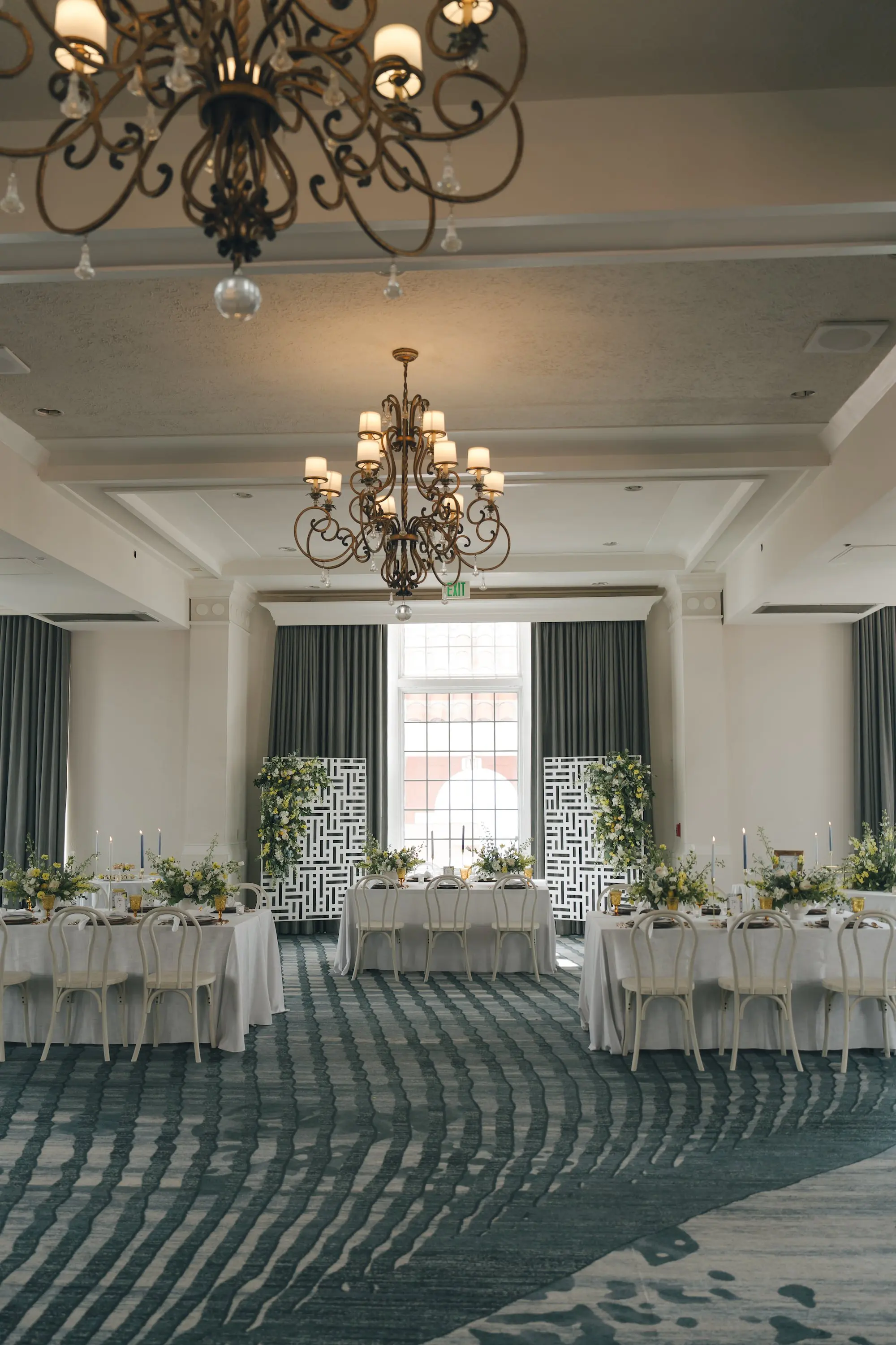 Luxurious Ballroom Wedding Reception | Wedding Venue Don CeSar | White and Yellow Floral Arrangements Reception Decor with Short White Vases and Yellow Depression Glass Inspiration | White Linens with Classic White Chairs with Romantic Taper Candlelight and White Roses with Greenery Wedding Reception Decor Inspiration | Kate Ryan Event Rentals | Tampa Bay Over The Top Rental Linens | Tampa Bay Planner Planner Coastal Coordinating