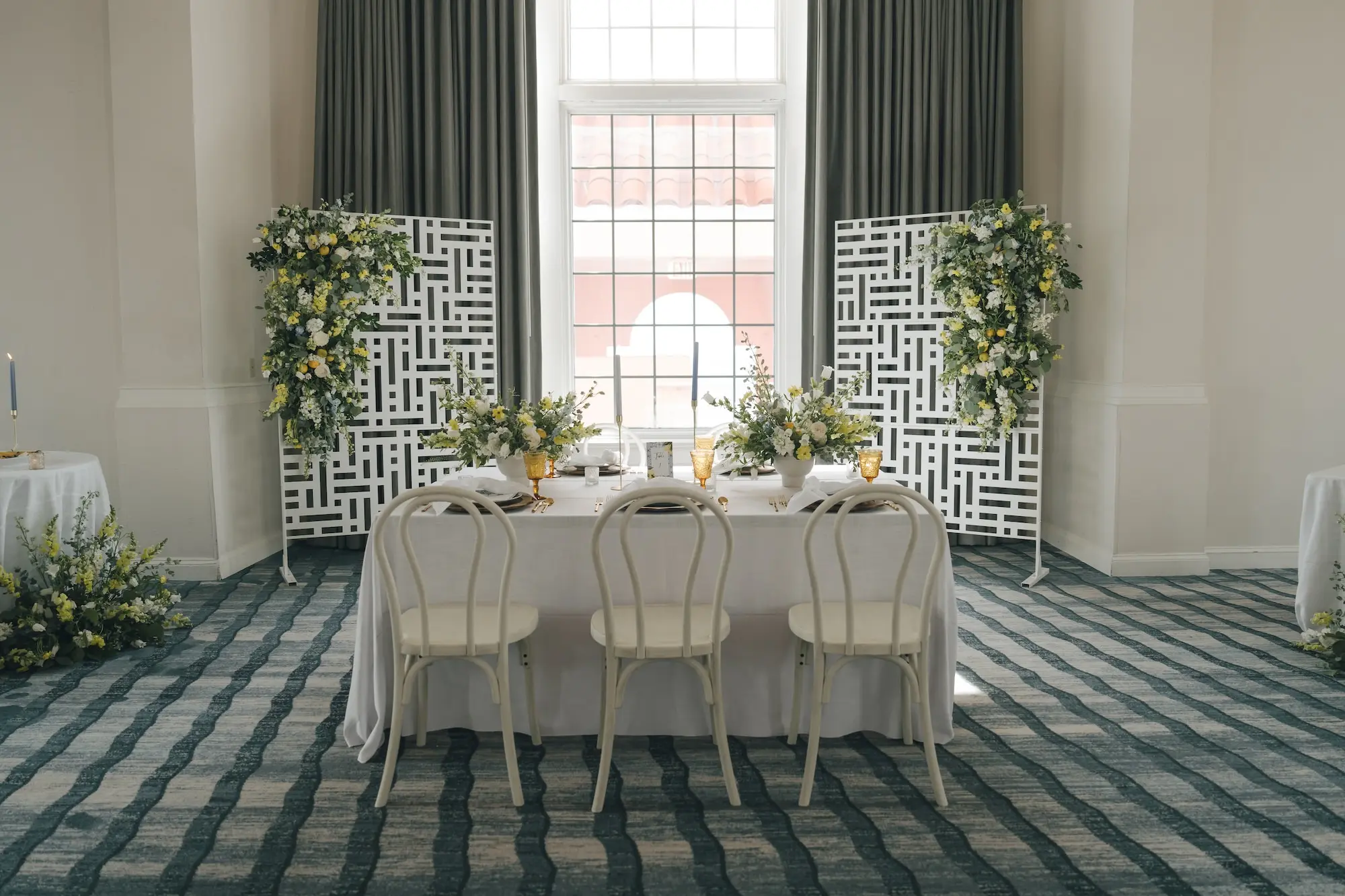 Luxurious Ballroom Wedding Reception | Wedding Venue Don CeSar | White and Yellow Floral Arrangements Reception Decor with Short White Vases and Yellow Depression Glass Inspiration | White Linens with Classic White Chairs with Romantic Taper Candlelight and White Roses with Greenery Wedding Reception Decor Inspiration | Kate Ryan Event Rentals | Tampa Bay Over The Top Rental Linens | Tampa Bay Planner Planner Coastal Coordinating