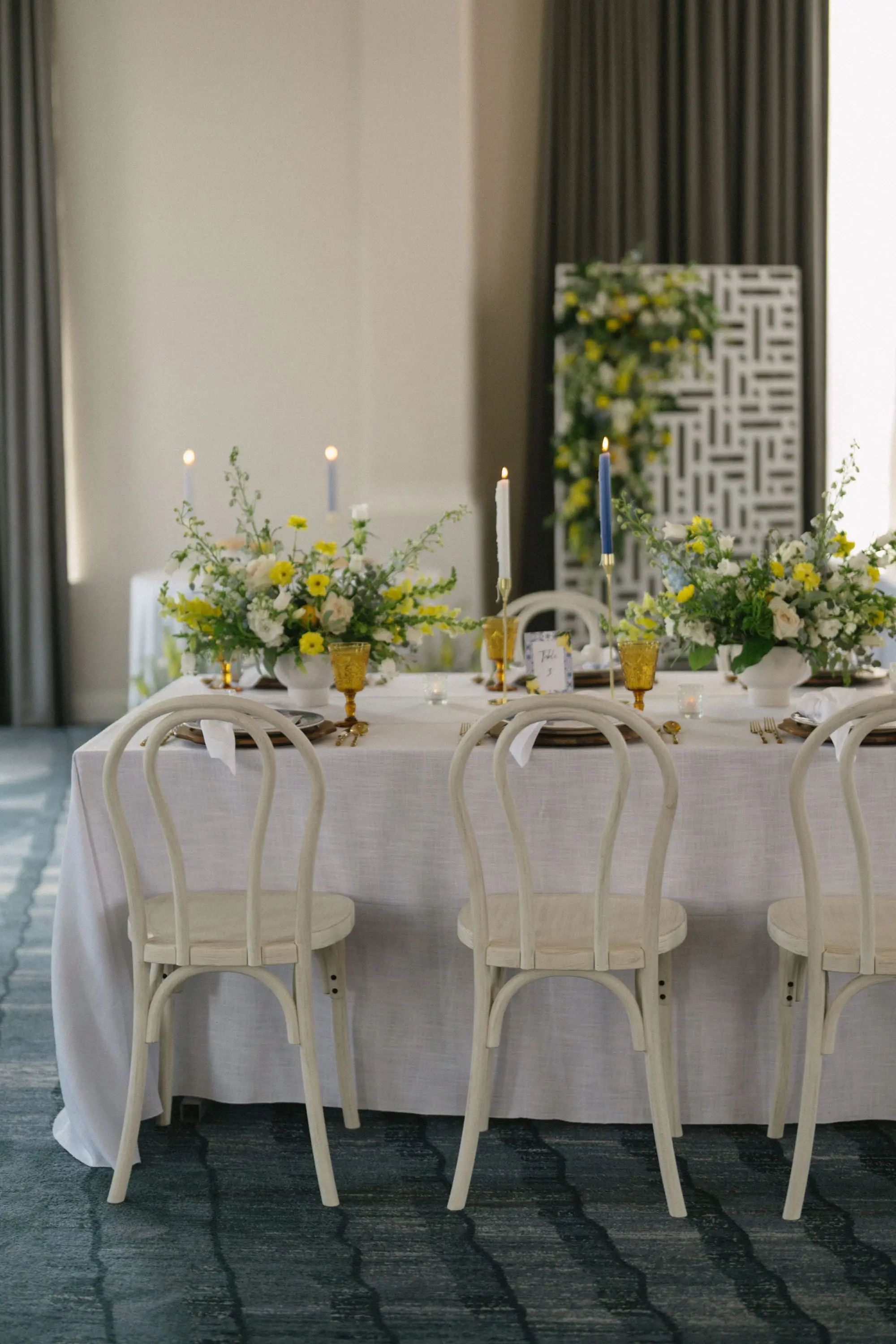 Luxurious Ballroom Wedding Reception | Wedding Venue Don CeSar | White and Yellow Floral Arrangements Reception Decor with Short White Vases and Yellow Depression Glass Inspiration | White Linens with Classic White Chairs with Romantic Taper Candlelight and White Roses with Greenery Wedding Reception Decor Inspiration | Kate Ryan Event Rentals | Tampa Bay Over The Top Rental Linens | Tampa Bay Planner Planner Coastal Coordinating