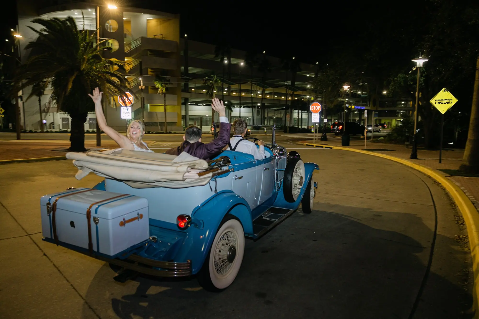 Bride and Groom Waving in Getaway Car Wedding Portrait | Vintage Blue Wedding Reception Getaway Car Ideas | Tampa Bay Content Creator Behind The Vows