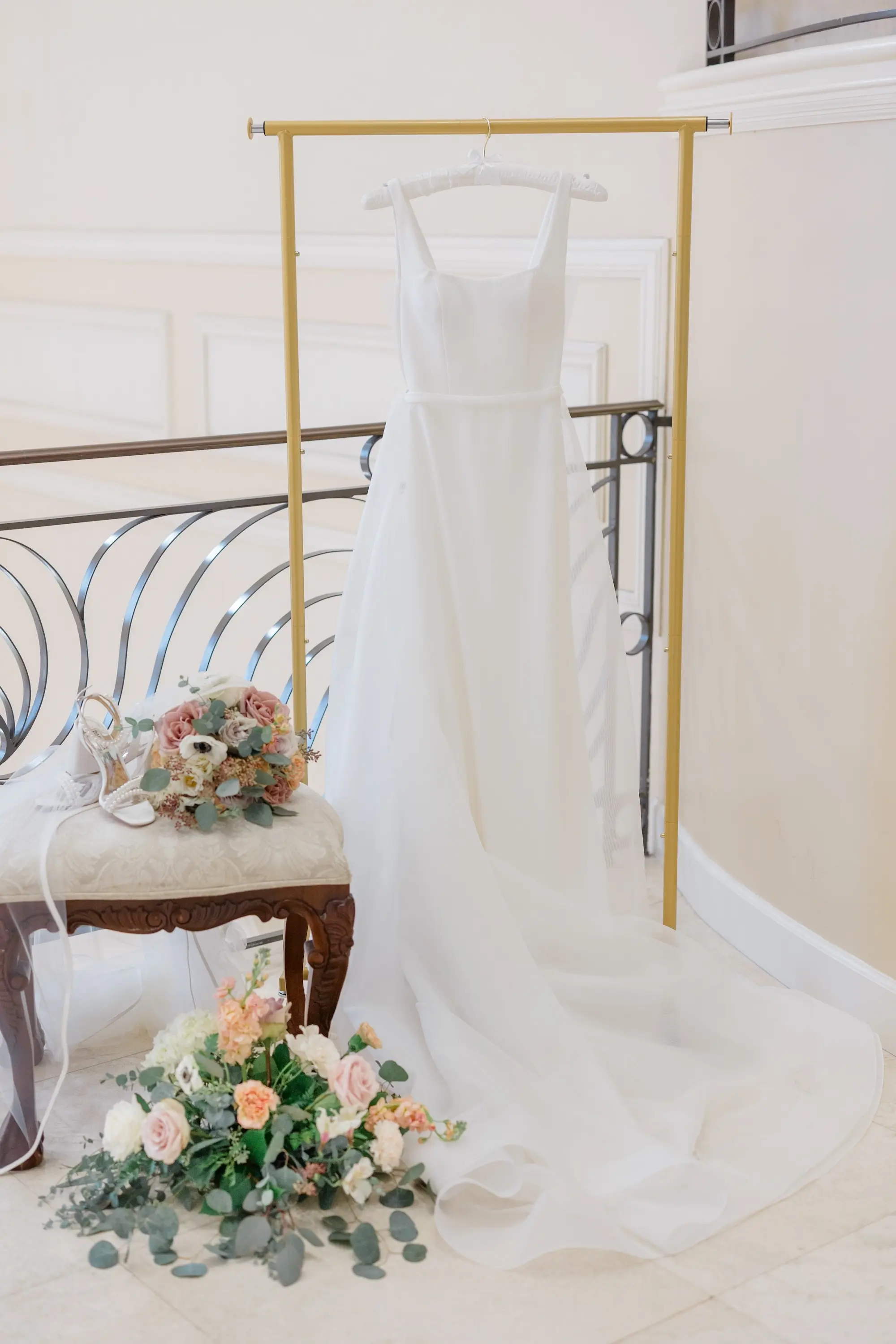 6Romantic Pastel and Navy Sarasota Wedding Inspiration jpg - Timeless Gold and Green Sarasota Wedding | Lakewood Ranch Golf & Country Club A-Line Paloma Blanca Wedding Gown with Scoop Neckline and Crepe Bodice hanging from Gold Clothes Rack Inspiration | Bridal Wedding Bouquet In Light Pastel Peach, Pink, and White Roses with Eucalyptus Leaves Ideas