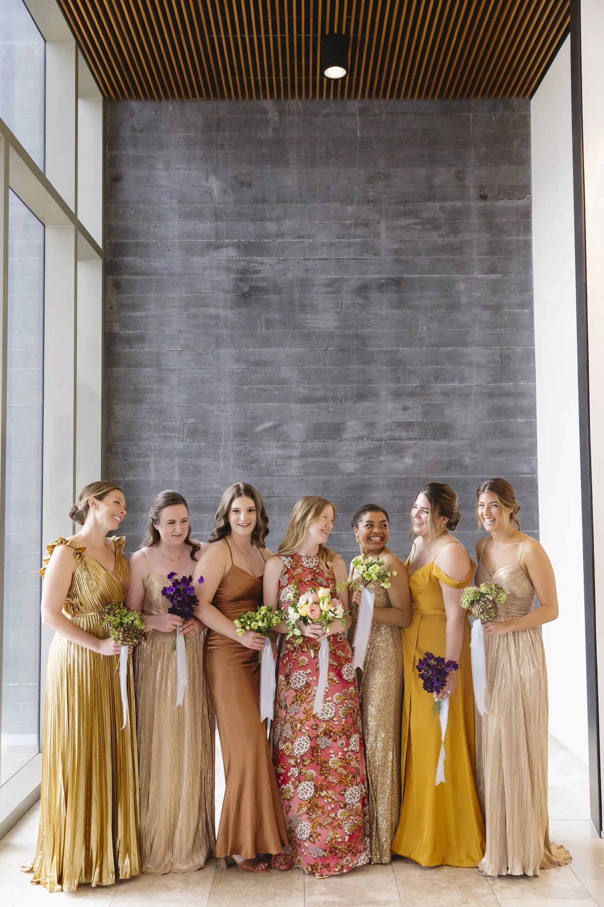 Bride and Bridesmaids Wedding Portrait | Rosy Pink Floral Mary Katrantzou Wedding Gown with Dramatic Cape Inspiration | Different Style and Color Bridesmaid Dresses in Gold, Bronze and Copper Shades | Different Bridal Bouquets with Violets, Lilies, Hydrangeas, and Roses Ideas | St Pete Florist Bruce Wayne Florals