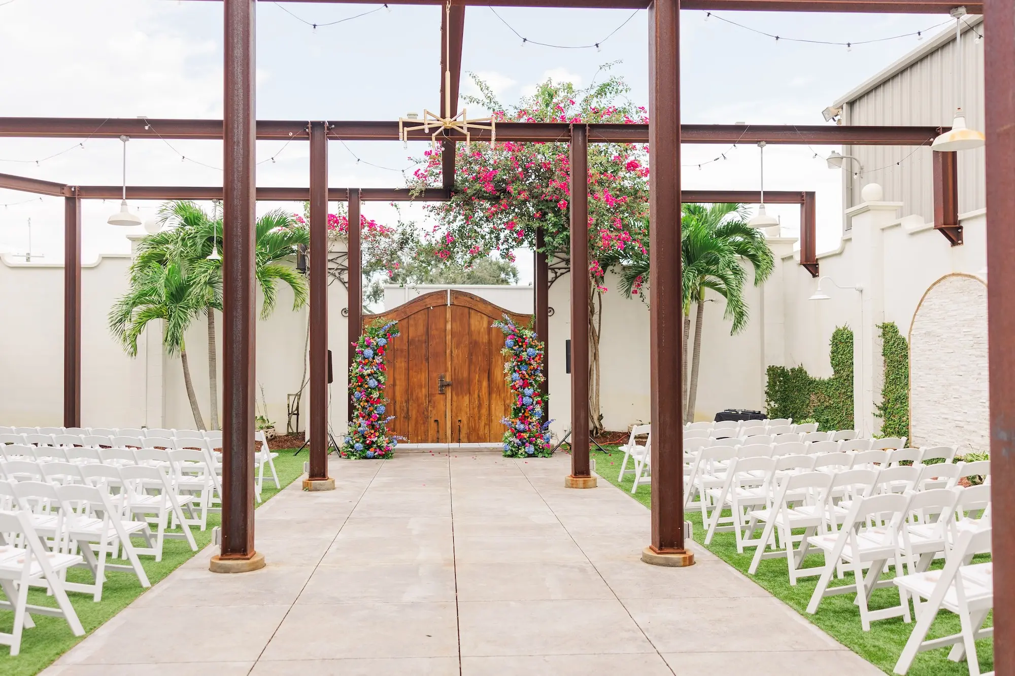 11Vibrant Blue Mexican Wedding Ideas Central Florida Venue 650 - Blue Mexican-Inspired Winter Haven Wedding | Venue 650 Bright Mexican Blue Fall Florida Outdoor Wedding Ceremony Inspiration | White Ceremony Chairs Ideas | Vibrant Red, Blue and Green Floral Ceremony Altar Decor Arrangements Inspiration | Chair Rentals A Chair Affair | Industrial Garden Wedding Venue Venue 650