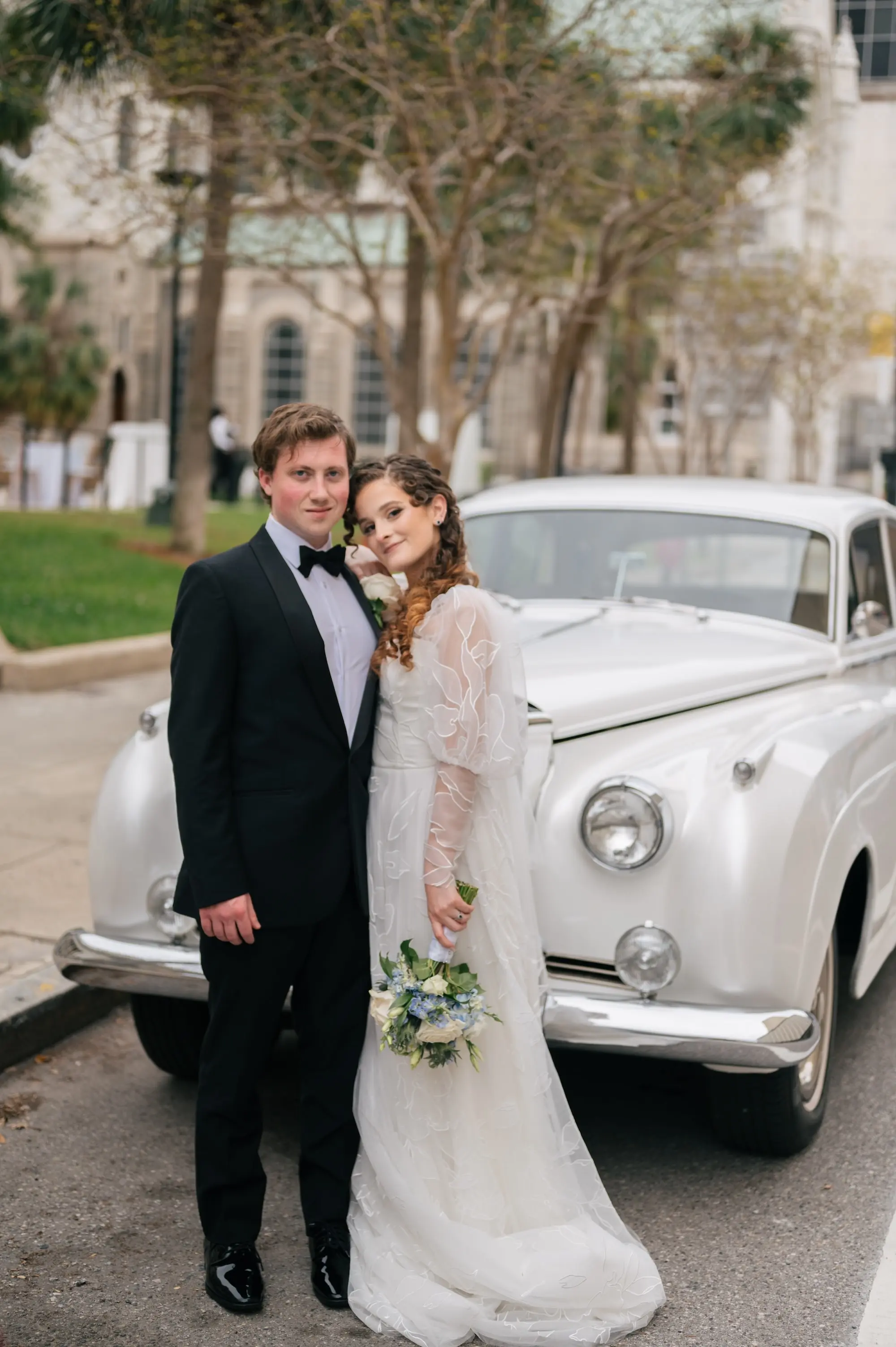 Bride and Groom Wedding Portrait in Front of Vintage White Car