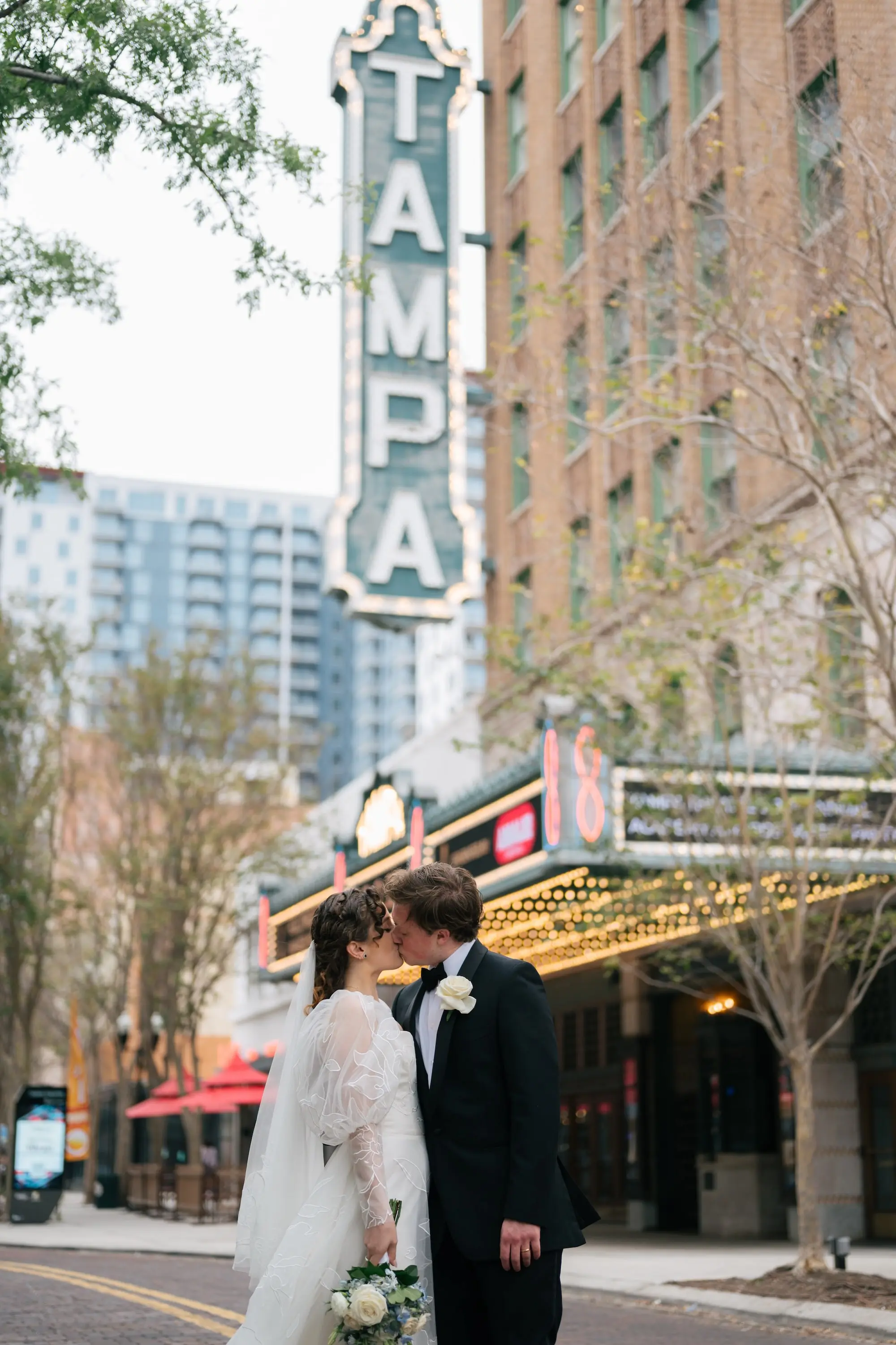 Bride and Groom Kissing in Front of Downtown Tampa Theater Marquis