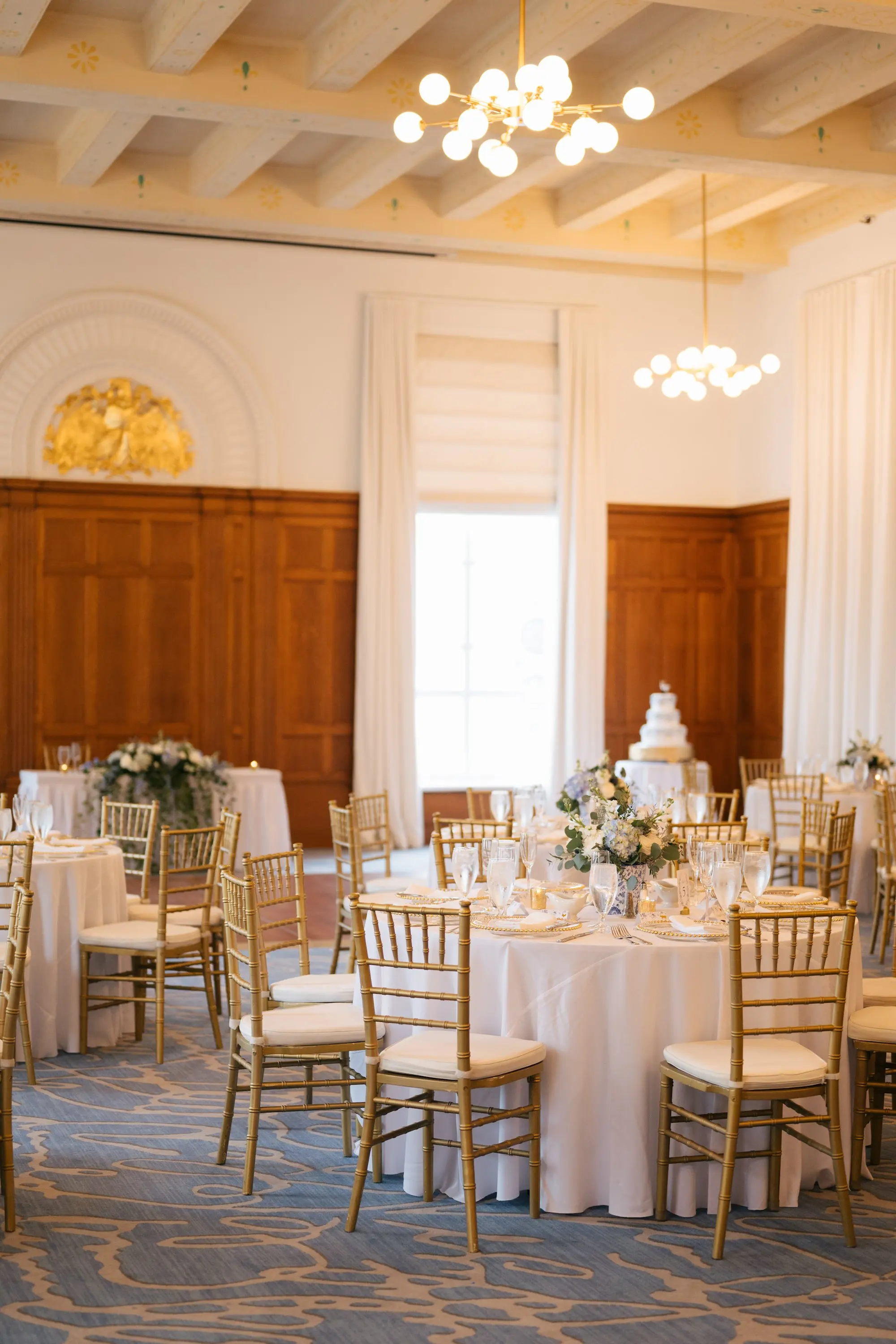 Luxurious Ballroom Wedding Reception | Modern Gold Chairs and Round Tables with White Linens Inspiration | Short Lush White Roses with White Baby's Breath Centerpiece Flower Arrangement Ideas | Venue Downtown Tampa Wedding Venue Le Meriden Hotel