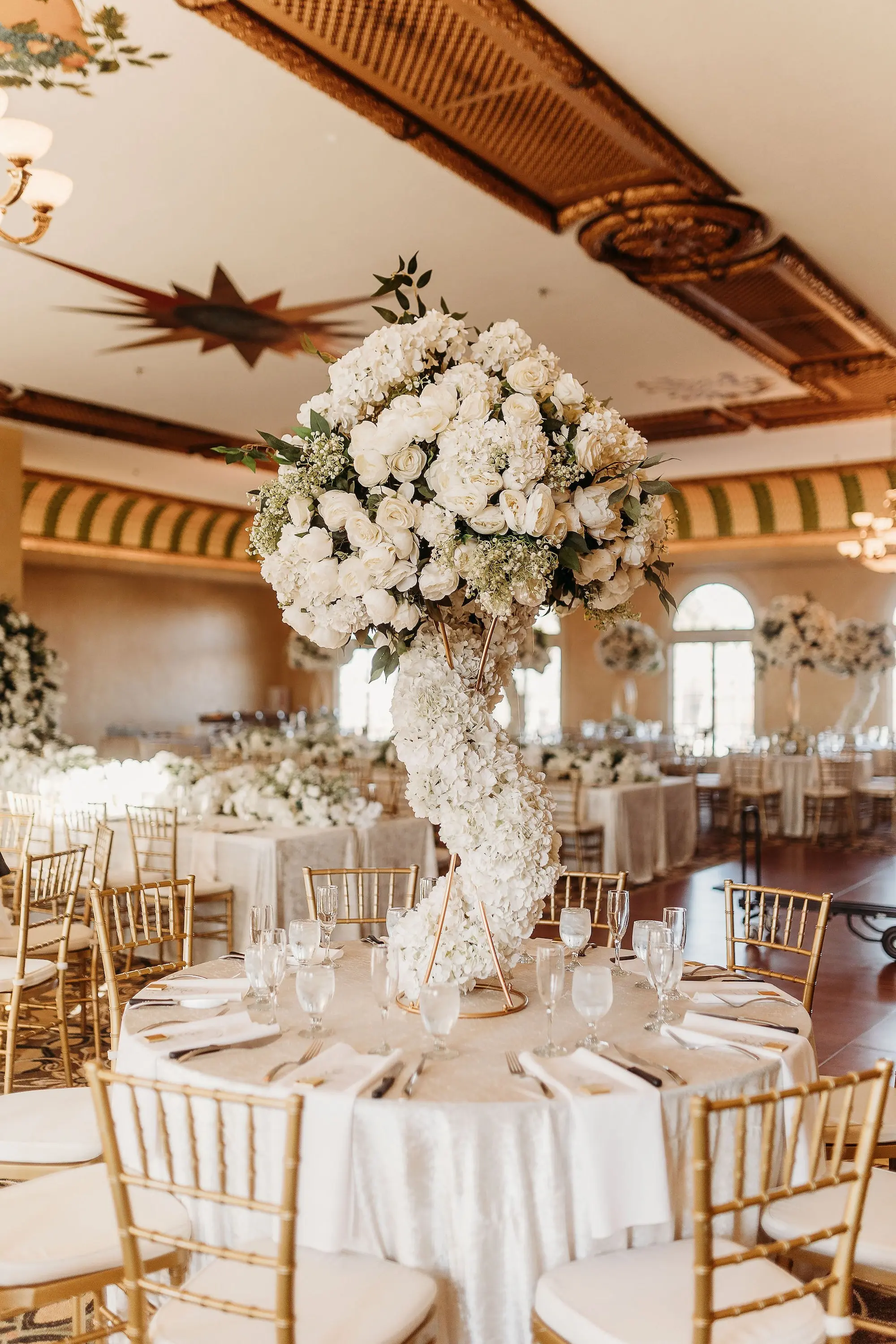 32Classic Gold Italian Inspired Wedding Ideas - Classic, Gold Tampa Wedding | The Italian Club of Tampa Elegant Old World Italian Inspired Ballroom Wedding Reception | Chiavari Gold Chairs | Tall Gold Lush Centerpieces with White Hydrangeas, Roses, and Baby's Breath with Greenery and White Rose Cascading Base Flower Arrangement Ideas | Downtown Tampa Ybor City Wedding Venue Italian Club
