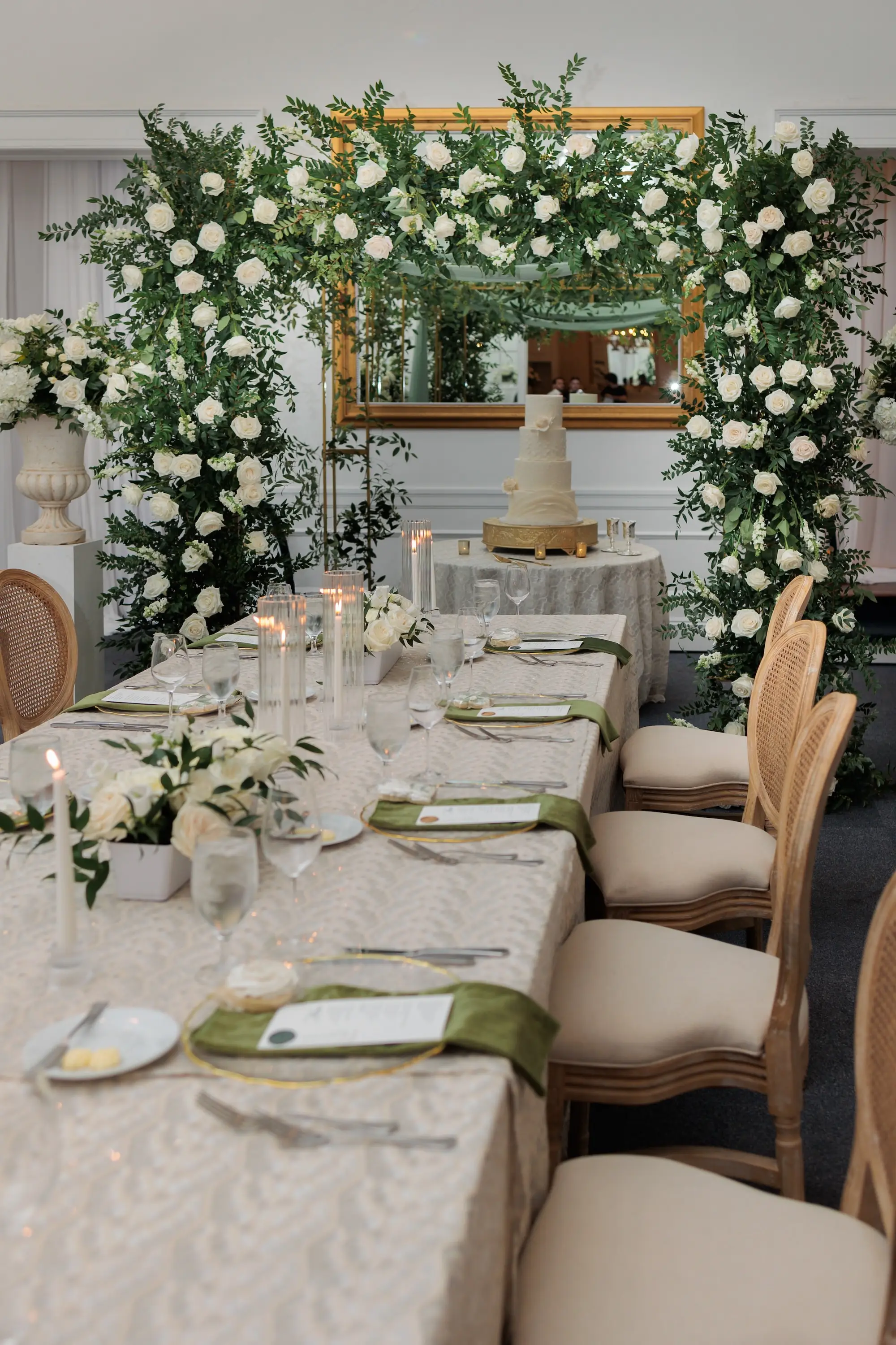 Timeless Ballroom Wedding Reception | Southern Wooden Rattan Chairs | Lush Elegant Centerpieces and Decor with White Roses, Greenery Eucalyptus Flower Arrangement Ideas | Soft White Taper Candle Decor Inspiration | White Linens with Gold Rimmed Chargers and Olive Green Napkins Tablescape Ideas | Romantic White Taper Candlelight Decor Inspiration | Tampa Bay Kate Ryan Event Rentals | Florist Save The Date Florida | Planner EventFull Weddings