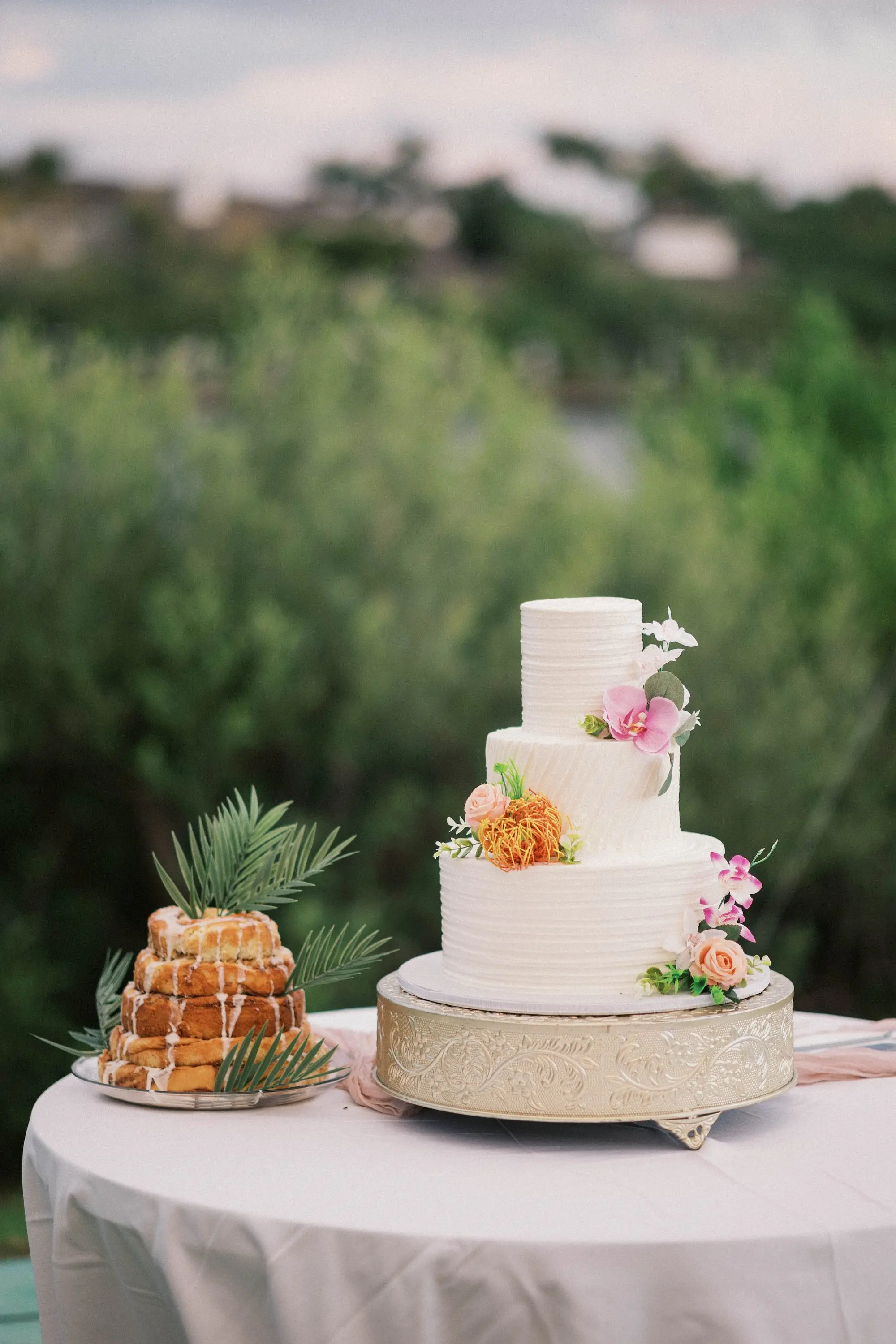 White Round Three-Tiered Wedding Cake with Pink and Orange Flower Decor Ideas