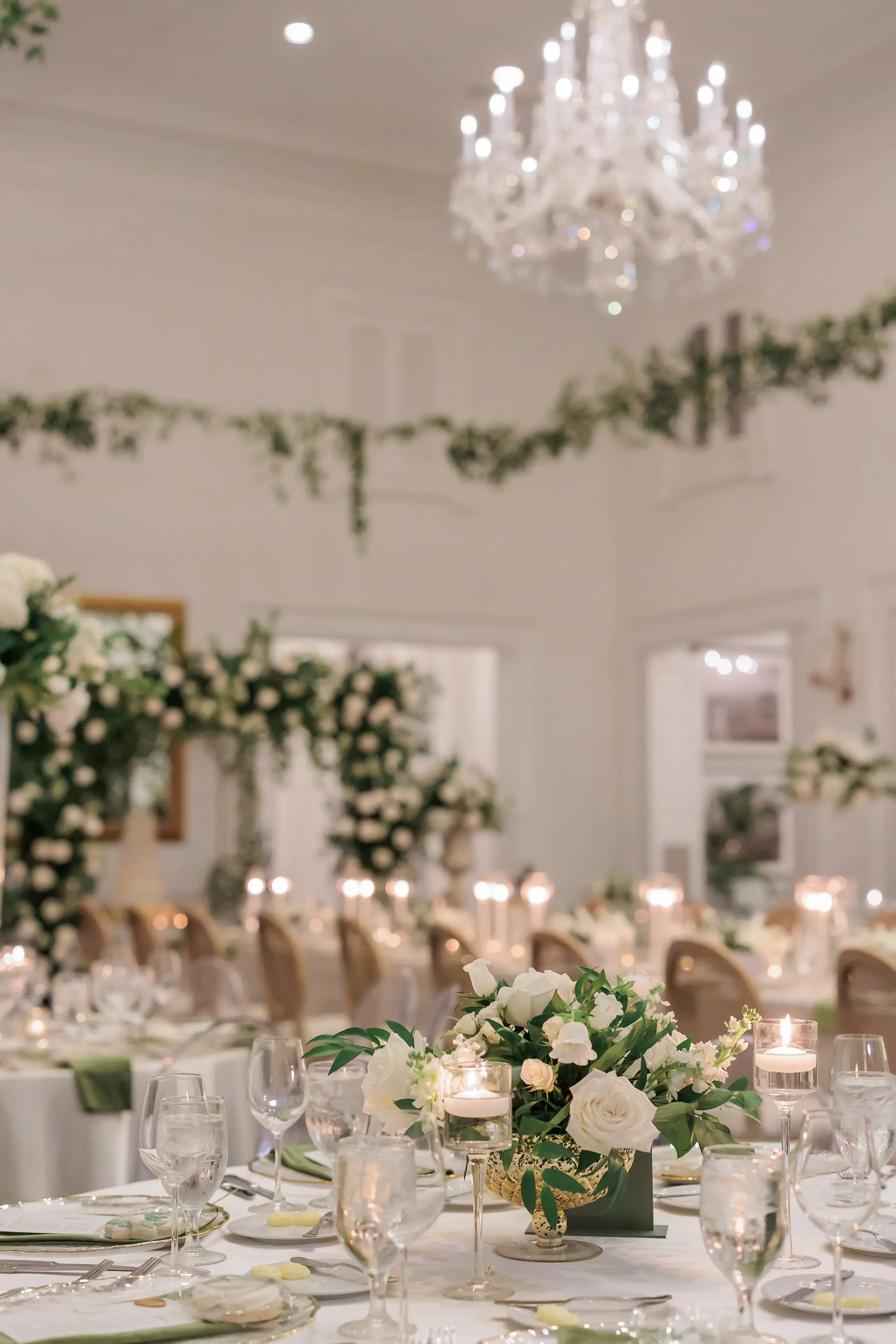Timeless Ballroom Wedding Reception | Modern Clear Ghost Chairs | Lush Elegant Centerpieces with White Hydrangeas, Roses, and Orchid Flower Arrangement Ideas | Greenery Eucalyptus Garland Decor Inspiration | White Linens with Olive Green Napkins and Romantic Candlelight Tablescape Decor Ideas | Tampa Bay Kate Ryan Event Rentals | Florist Save The Date Florida | Planner EventFull Weddings | Venue Tampa Yacht and Country Club