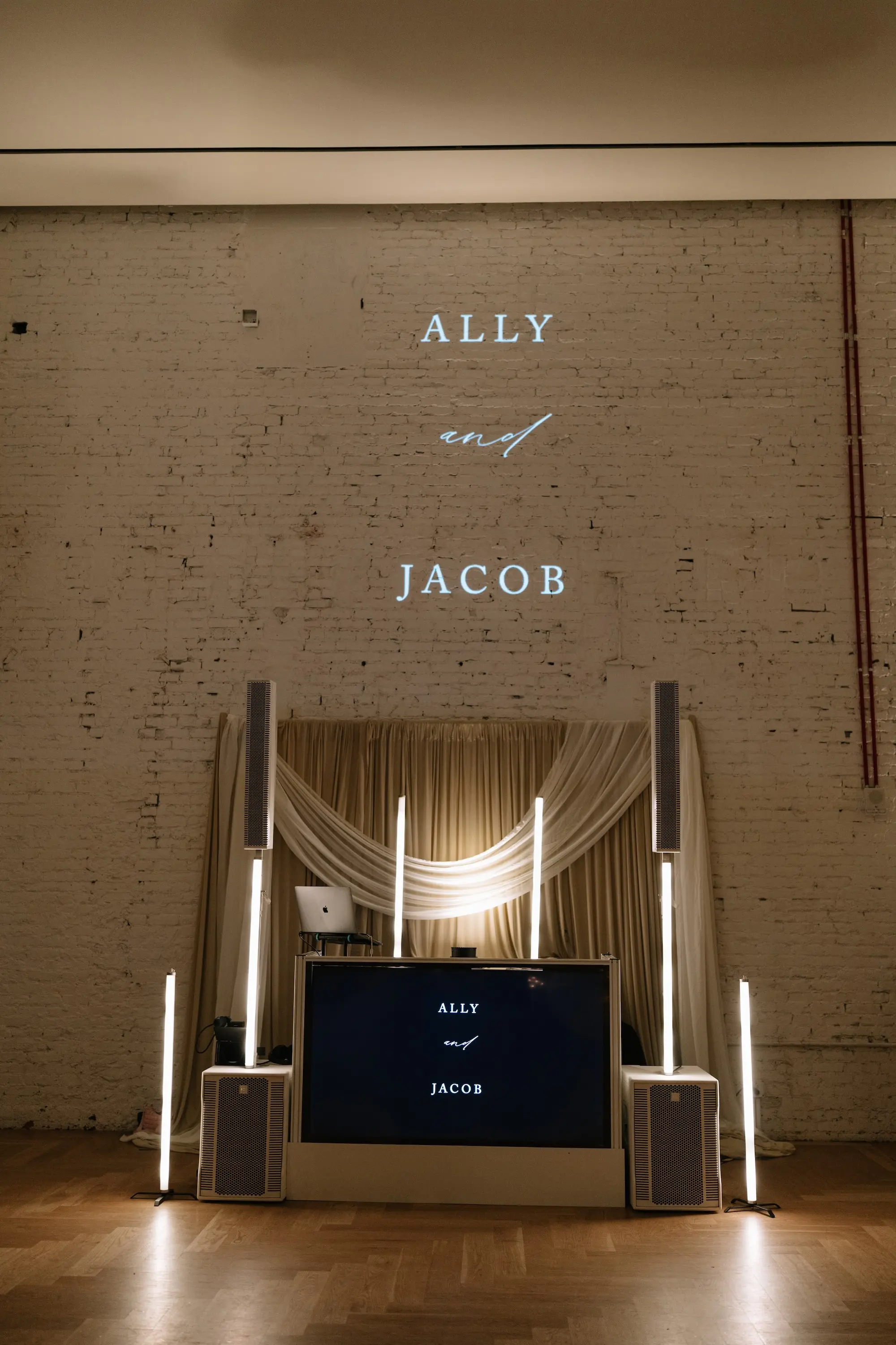Bride and Groom Names Projection on White Brick Accent Wall Behind the DJ Booth Ideas | Tampa Bay DJ Company