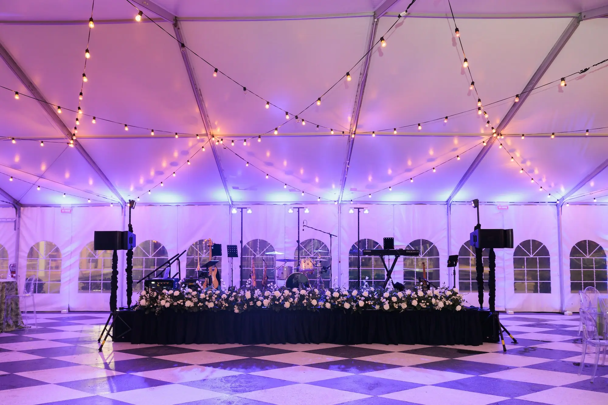 Timeless White Flowers and Greenery Tented Wedding Reception Band Stage Decor Ideas | Black and White Checkered Dance Floor Inspiration | Tent Wedding Reception Venue with String Lights Decor Ideas | Tampa Florist Save The Date Florida | Tampa Yacht and Country Club
