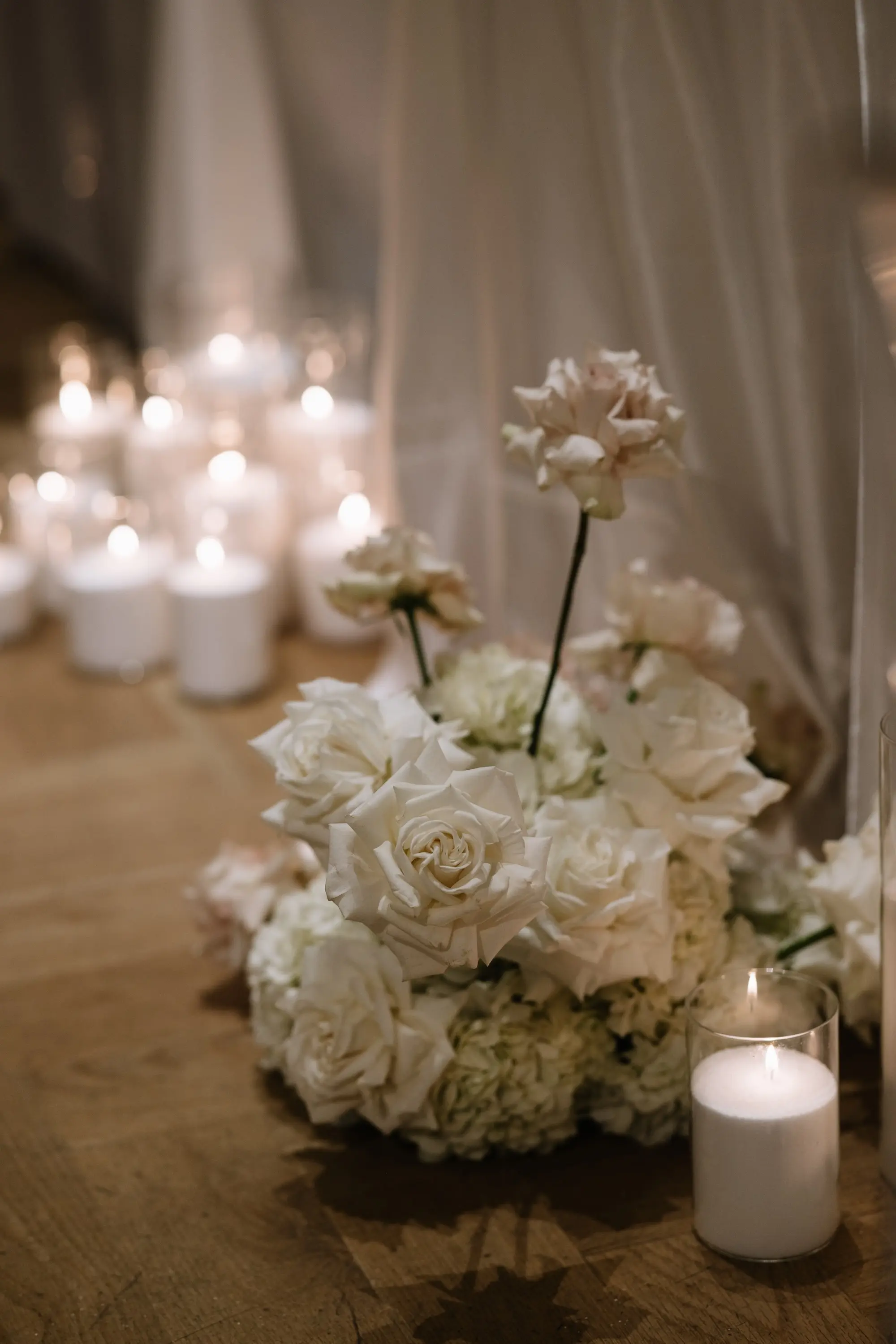 White Hydrangeas and Roses Floral Arrangement Wedding Reception Decor Inspiration | Large White Candles in Clear Glass Vases Decor Ideas