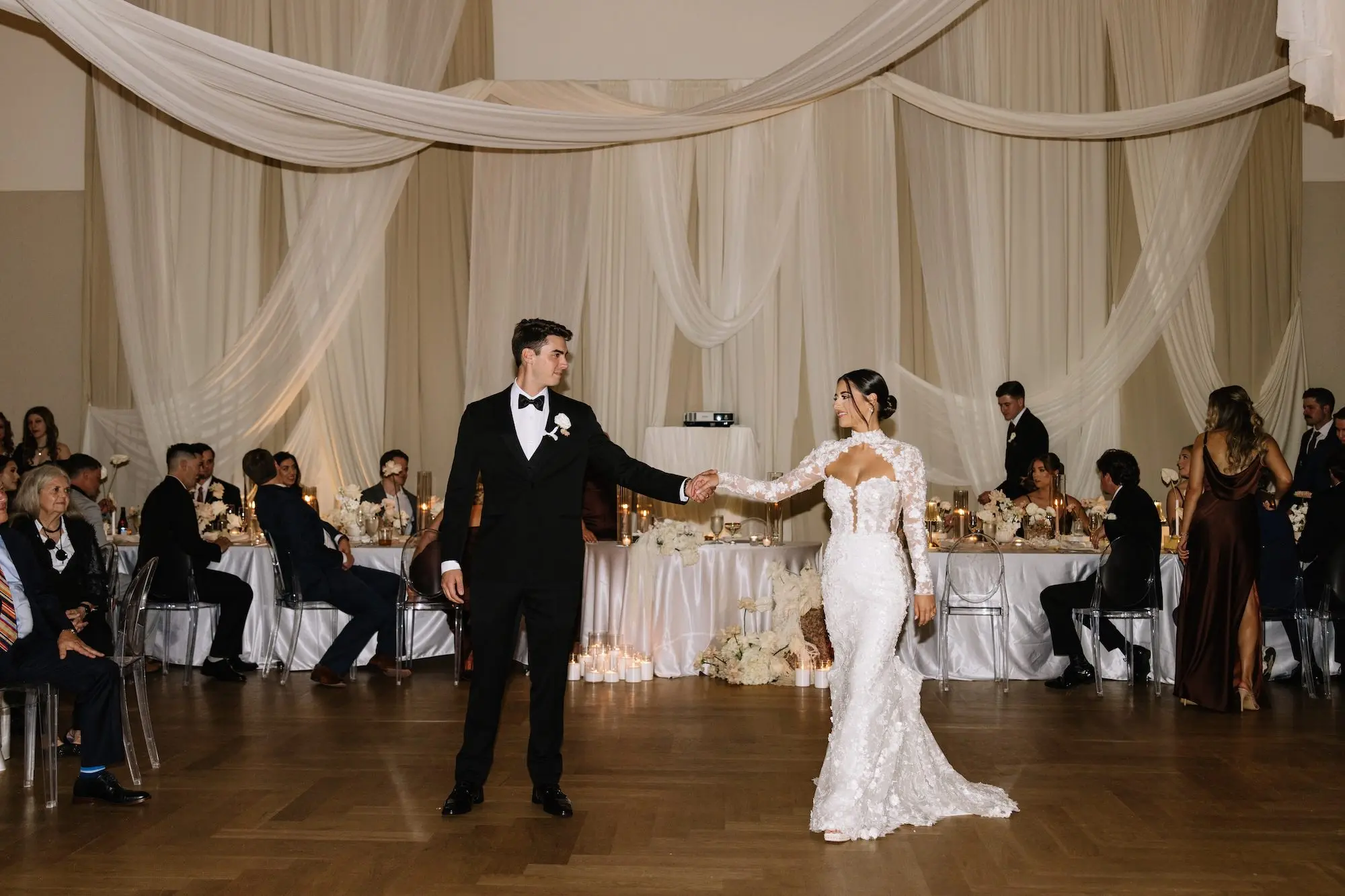 Bride and Groom First Dance Wedding Portrait | Tampa Bay DJ Company | Floral Lace Liz Young Fitted Silhouette Wedding Gown with Long Sleeves Inspiration | Traditional Black and White Groom Tuxedo Ideas | White Monochromatic Wedding Reception Decor Inspiration | Ybor City Venue Hotel Haya | Tampa Bay Planner EventFull Weddings