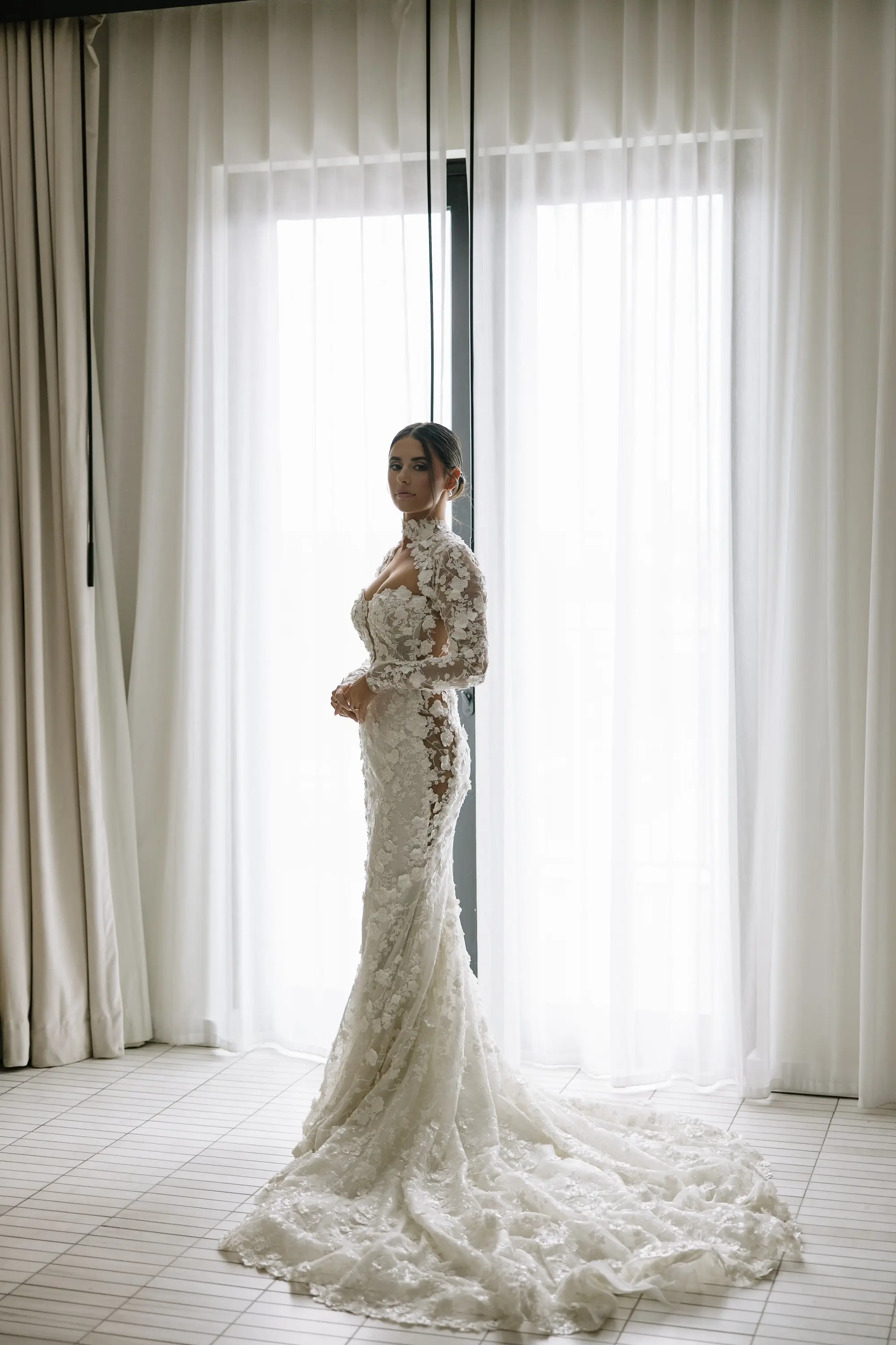 Bride Silhouette Wedding Portrait | Intricate Floral Lace Fitted Silhouette Liz Young Wedding Gown with Long Sleeves, High Neckline with a Bolero-Style Lace Overlay and Long Train Inspiration