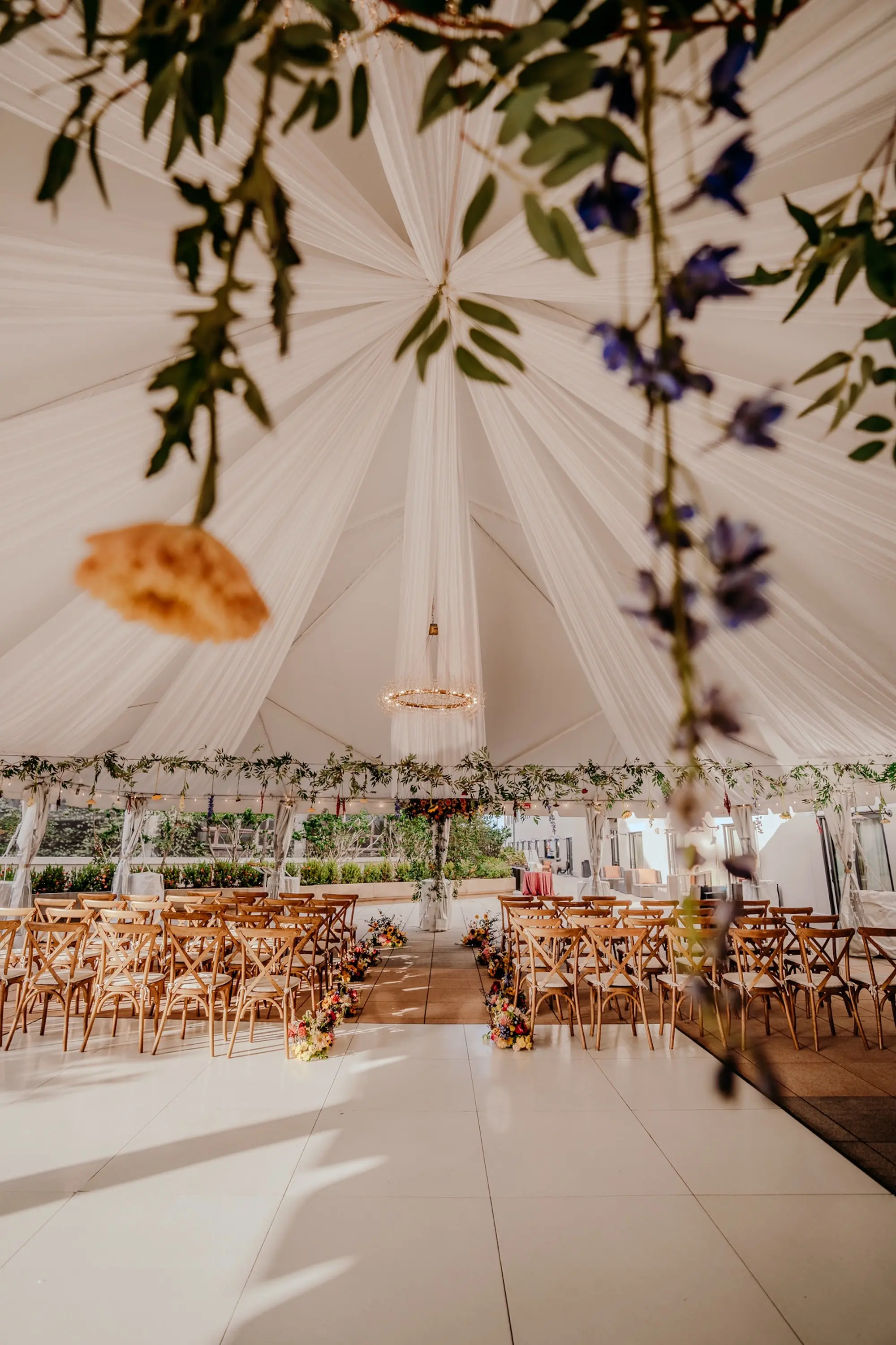 Colorful Floral Filled Tented Wedding Ceremony Decor Ideas | Greenery Garland, Pink and Yellow Flowers | Tampa Bay Event Venue The Epicurean | Planner Wilder Mind Events