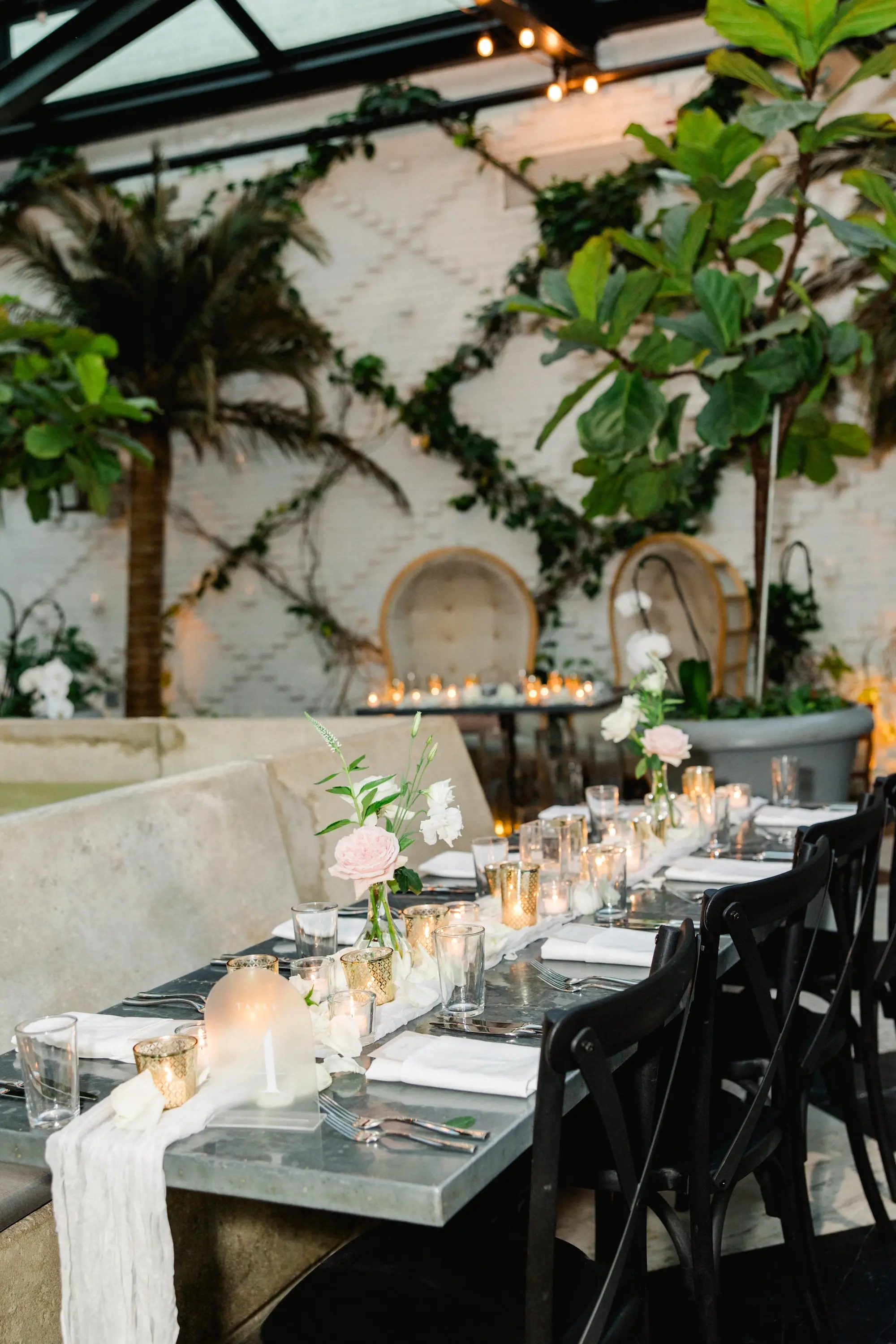 Romantic Black and White Wedding Reception Tabletop Decor Ideas | Pink and White Flowers in Bud Vases Centerpiece Inspiration | Dreamy, Soft Candle Reception Table Decor on White Table Runner with Black Chairs Ideas | Tampa Bay Event Venue Oxford Exchange