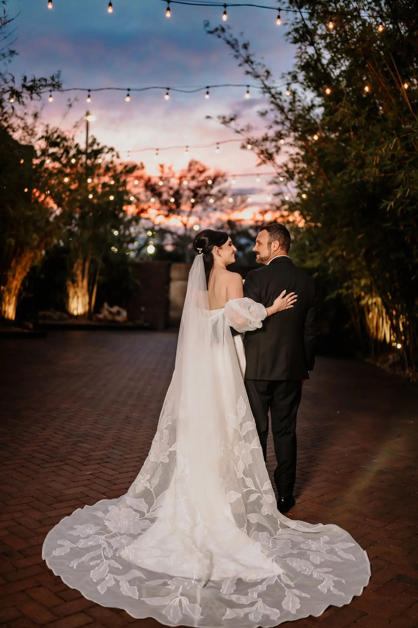 Bride and Groom Wedding Portrait Under String Lights in Outside Space | Cathedral Length Chiffon Veil Ideas | Custom Floral Detailed Jenny Woo Bridal Cape Ideas | Tampa Bay Photographer Sabrina Autumn Photography | Downtown St Pete Venue NOVA 535