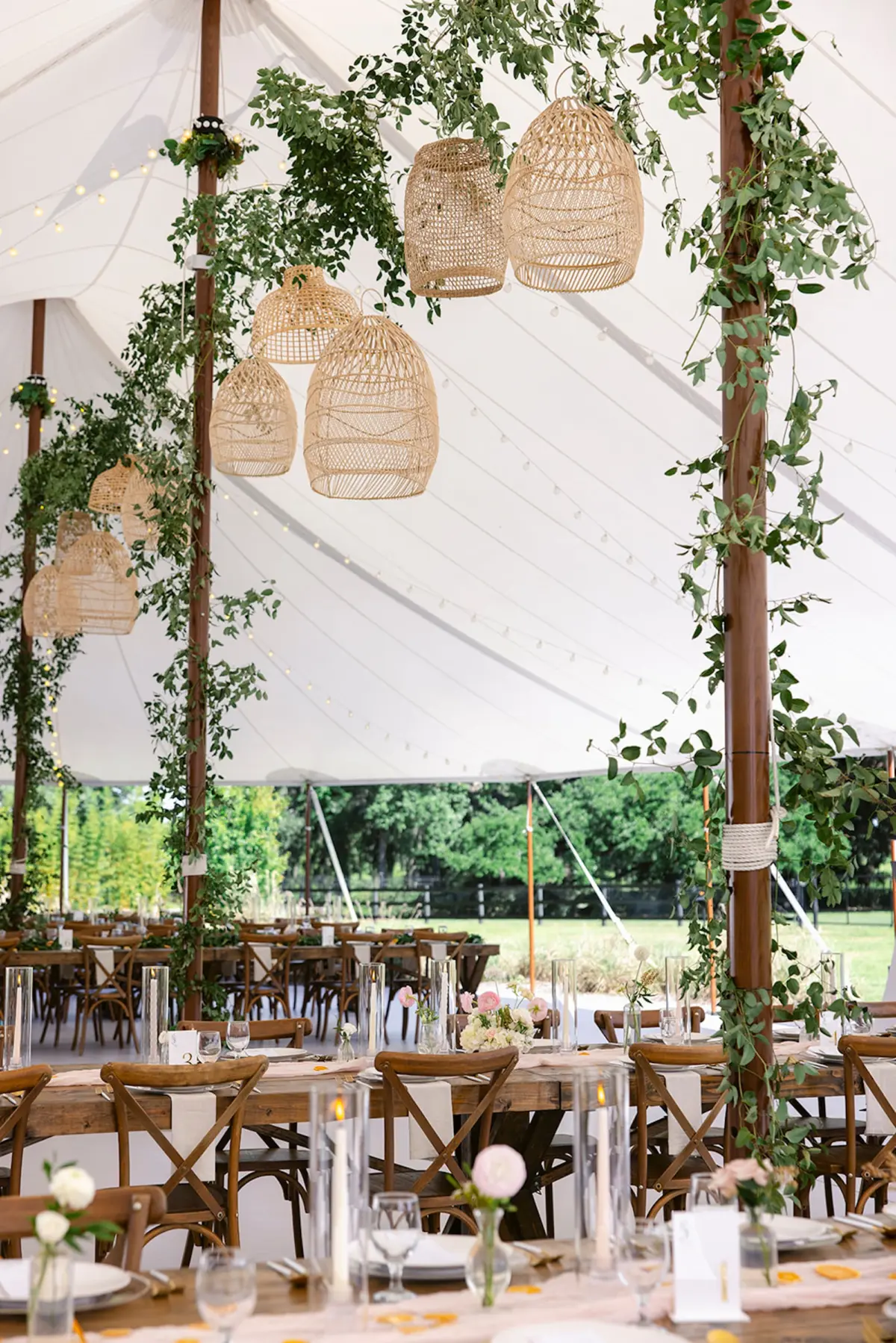 Estate Green Outdoor Tented Wedding Reception Inspiration | Woven Baskets and Eucalyptus Garland Wedding Reception Decor Ideas | Long Wooden Wedding Reception Tables with White Taper Candles Centerpiece Tablescape Decor Inspiration | Tampa Bay Planner Wilder Mind Events