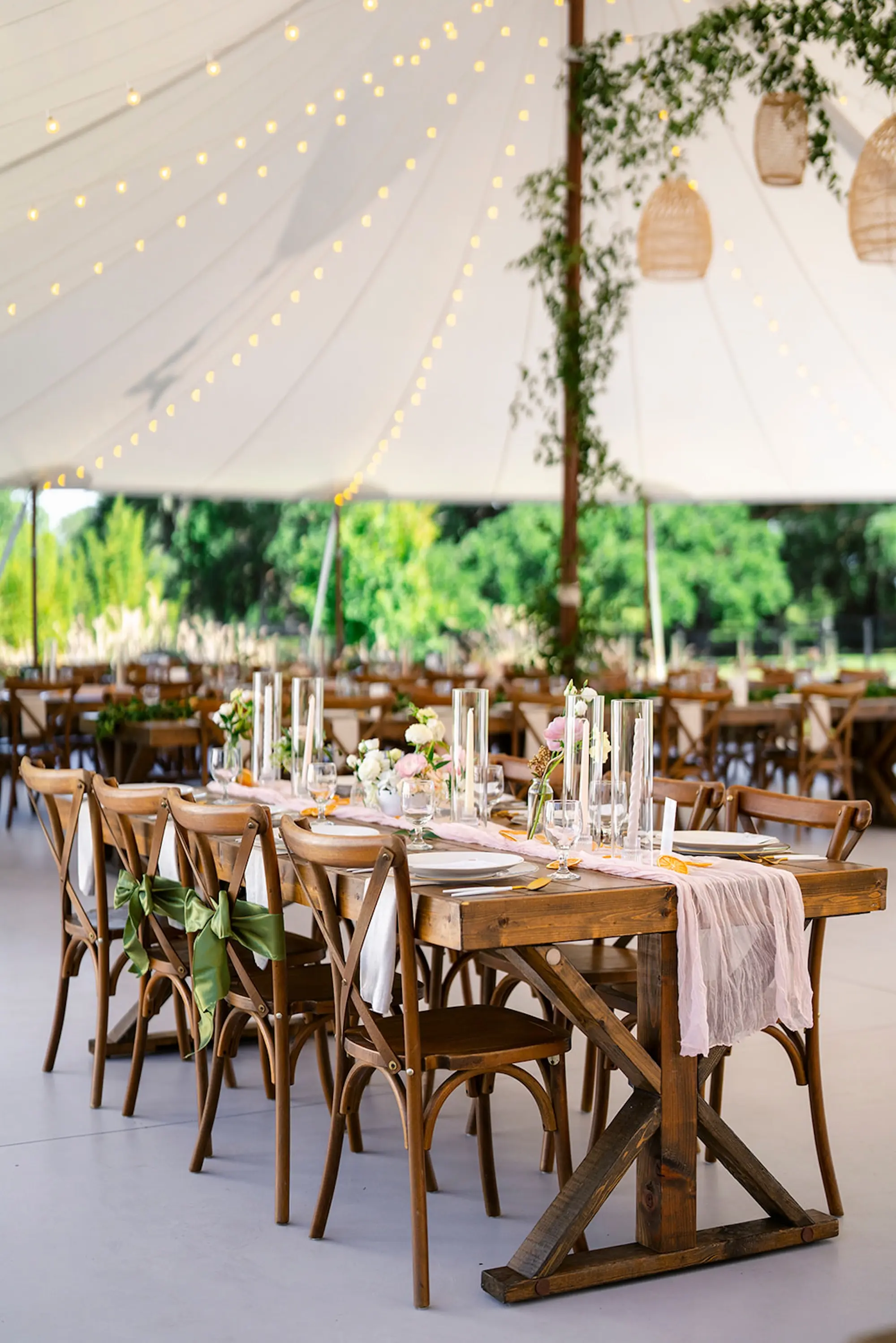 Estate Green Outdoor Tented Wedding Reception Inspiration | Woven Baskets and Eucalyptus Garland Wedding Reception Decor Ideas | Long Wooden Wedding Reception Tables with White Taper Candles Centerpiece Tablescape Decor Inspiration | Tampa Bay Planner Wilder Mind Events