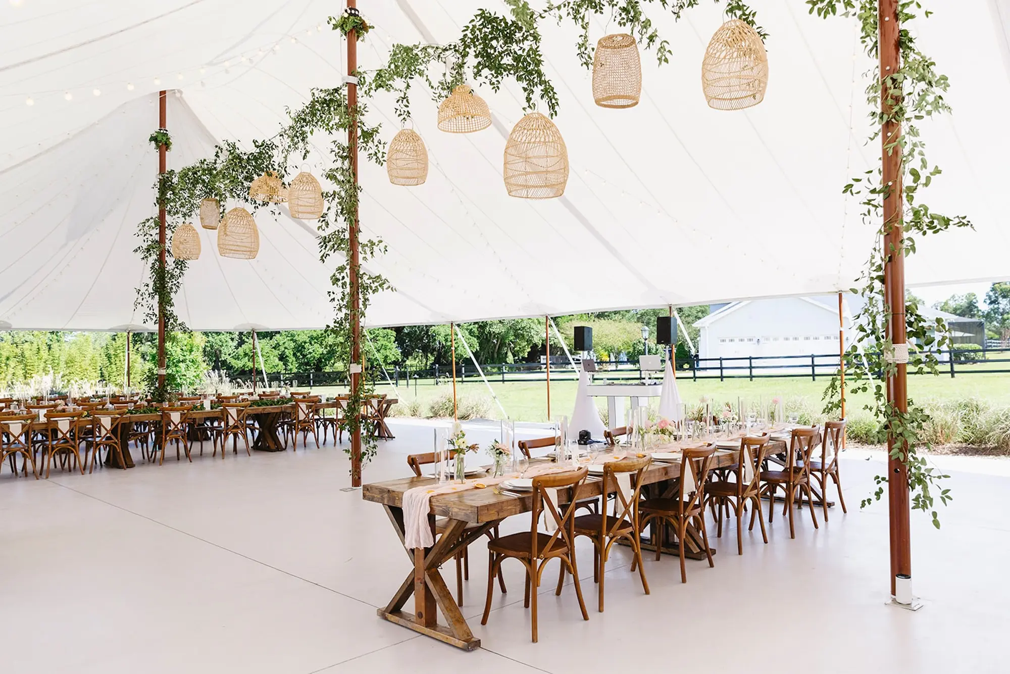 Estate Green Outdoor Tented Wedding Reception Inspiration | Woven Baskets and Eucalyptus Garland Wedding Reception Decor Ideas | Long Wooden Wedding Reception Tables with White Taper Candles Centerpiece Tablescape Decor Inspiration | Tampa Bay Planner Wilder Mind Events | Venue Mill Pond Estate | Caterer Elite Events Catering