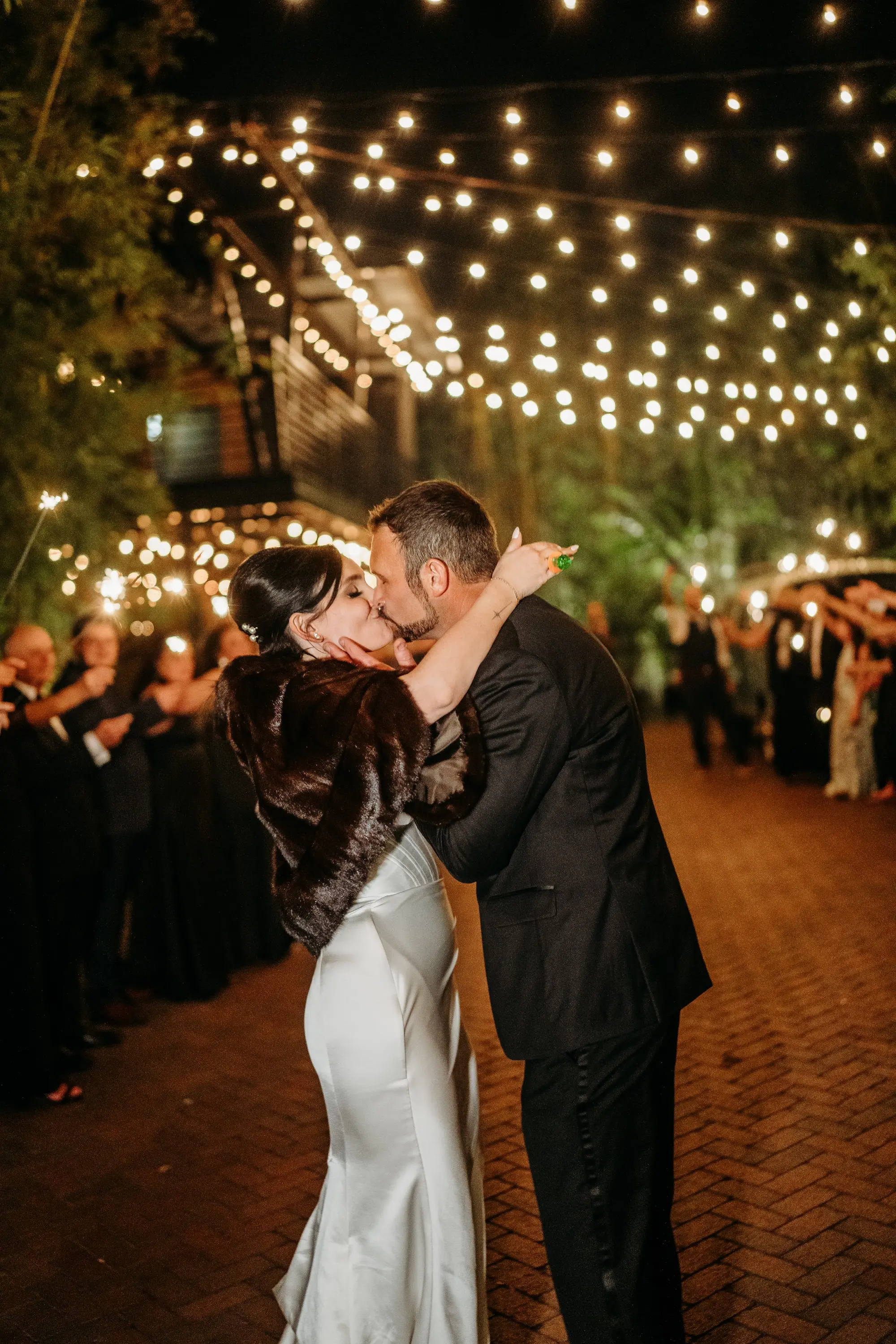Bride and Groom Outdoor Wedding Reception Exit under String Light Portrait | Brown Fur Bridal Stole Wrap Ideas | Downtown St Pete Wedding Venue NOVA 535 | Tampa Bay Photographer Sabrina Autumn Photography