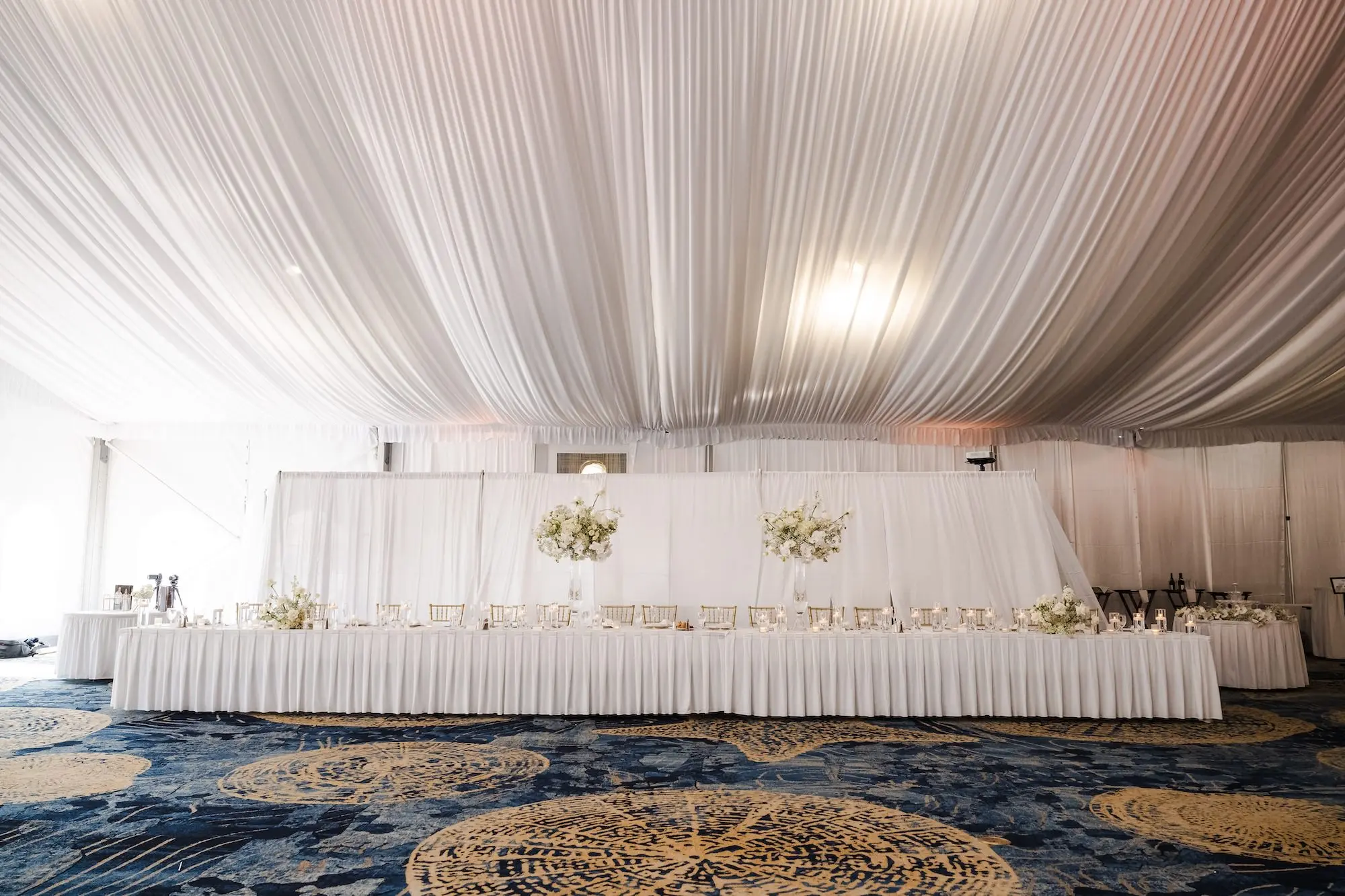 Classic Champagne and Black Florida Beach Tented Ballroom Wedding Reception | Gold Chiavari Chairs at Long Feasting Tables with White Linens Decor Inspiration | St Pete Beach Event Venue TradeWinds Island Resort