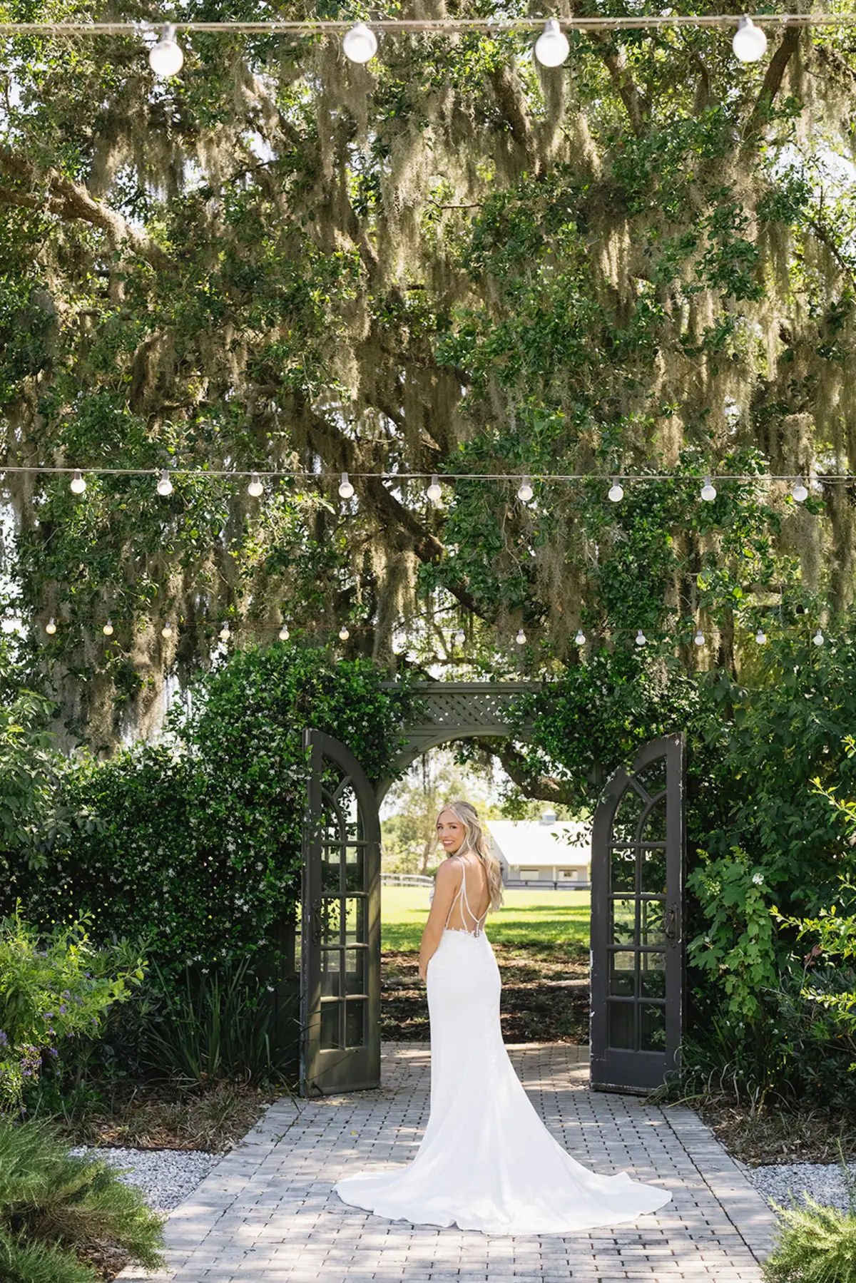Bride Wedding Portrait | White Fitted Intricate Lace White Closet Bridal Crepe Sheath Wedding Gown with Spaghetti Straps Inspiration | Half Up Half Don Soft Natural Curls Bridal Hair Ideas | Feminine Natural Blush Bridal Makeup Inspiration | Sarasota Hair and Makeup Artist Femme Akoi Beauty Studio | Event Venue Mill Pond Estate