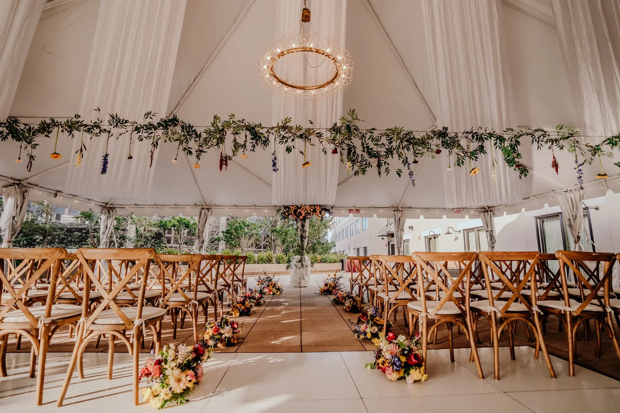 Colorful Floral Filled Tented Wedding Ceremony Decor Ideas | Greenery Garland, Pink and Yellow Flowers | Tampa Bay Event Venue The Epicurean | Planner Wilder Mind Events