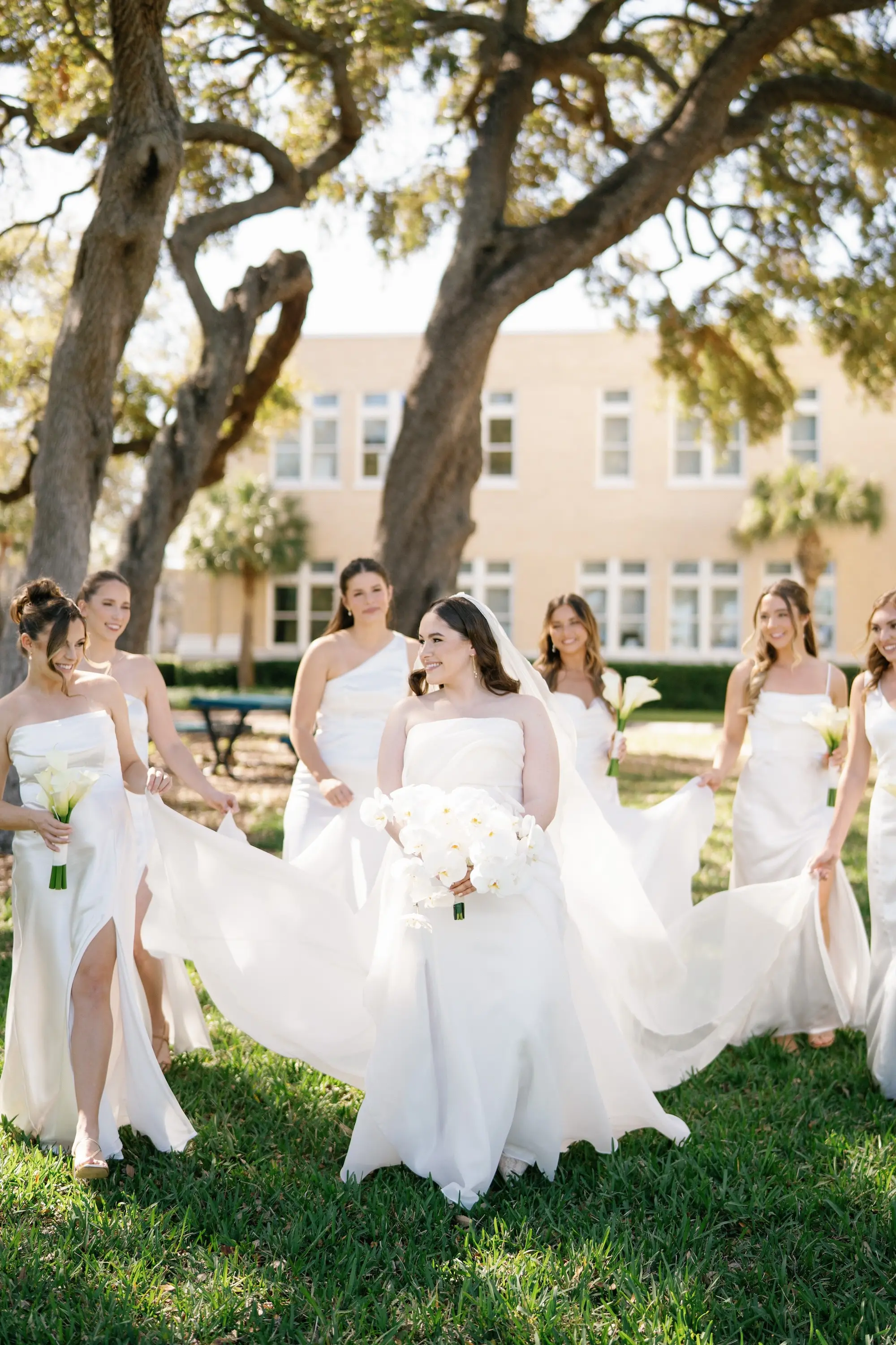 Bride and Bridesmaid Wedding Portrait | White Satin Mismatched Bridesmaid Dresses Inspiration | White Lilies with Long Stems Bouquet Ideas | White Orchid Bridal Bouquet Inspiration
