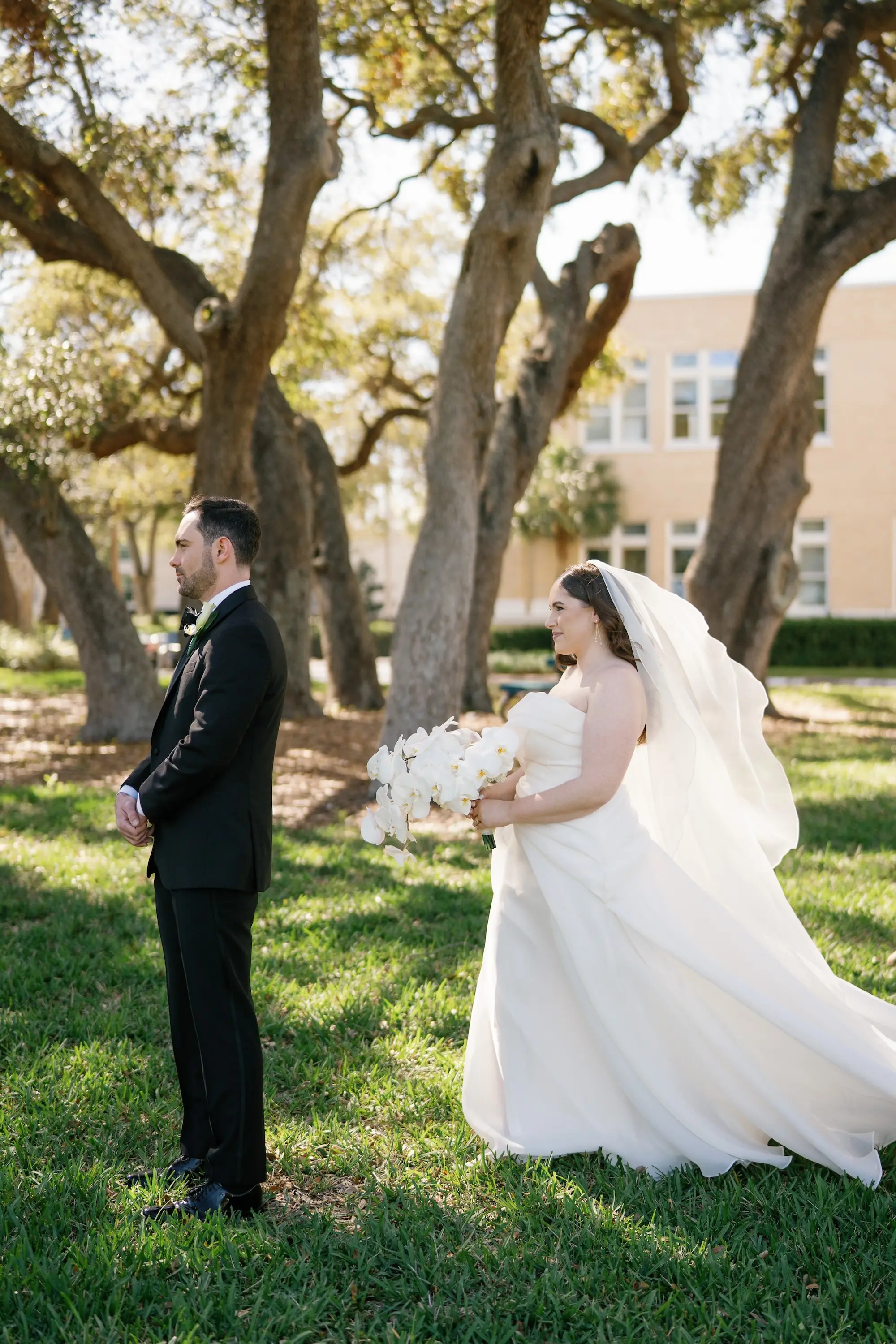 Bride and Groom First Look Wedding Portrait | White Orchid Bridal Bouquet Inspiration | Strapless White Wedding Ballgown with Cathedral Length Veil Ideas