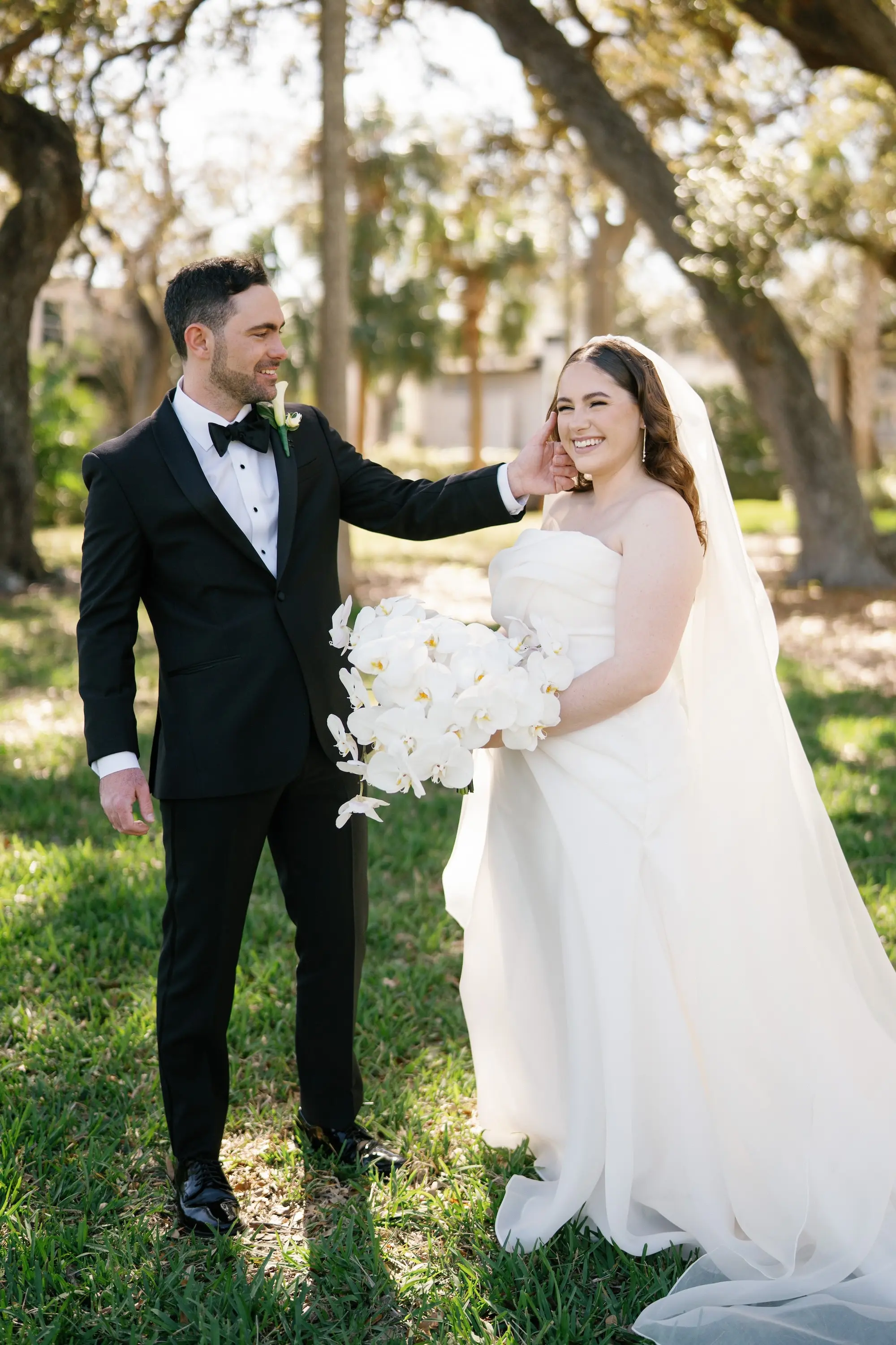 Bride and Groom First Look Wedding Portrait | White Orchid Bridal Bouquet Inspiration | Strapless White Wedding Ballgown with Cathedral Length Veil Ideas